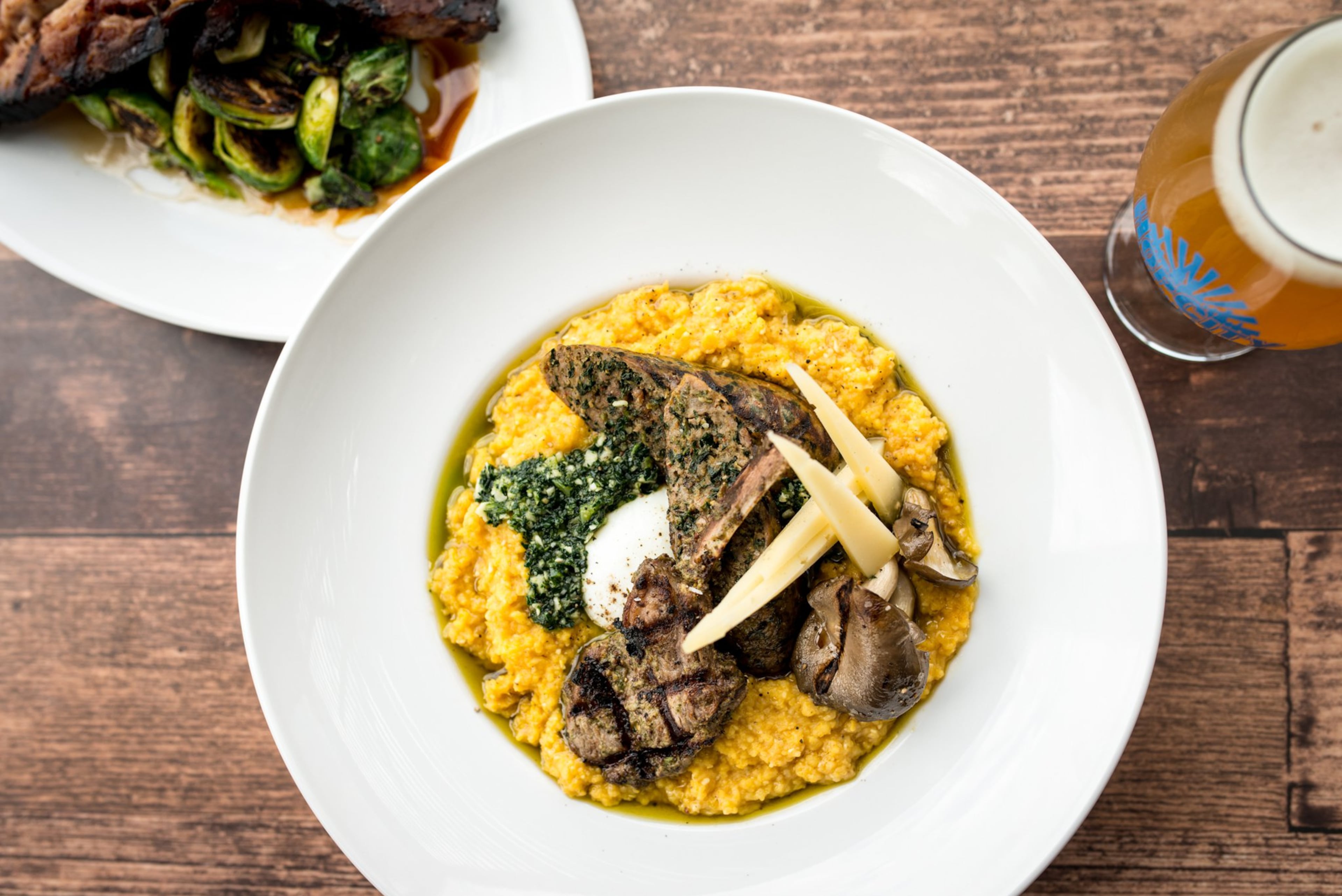 Lamb and Pumpkin Polenta with lamb and kale sausage, lamb chop, kale-almond pesto, poached egg, oyster mushroom, "Thomasville Tomme" and rosemary. Photo credit- Mia Yakel.