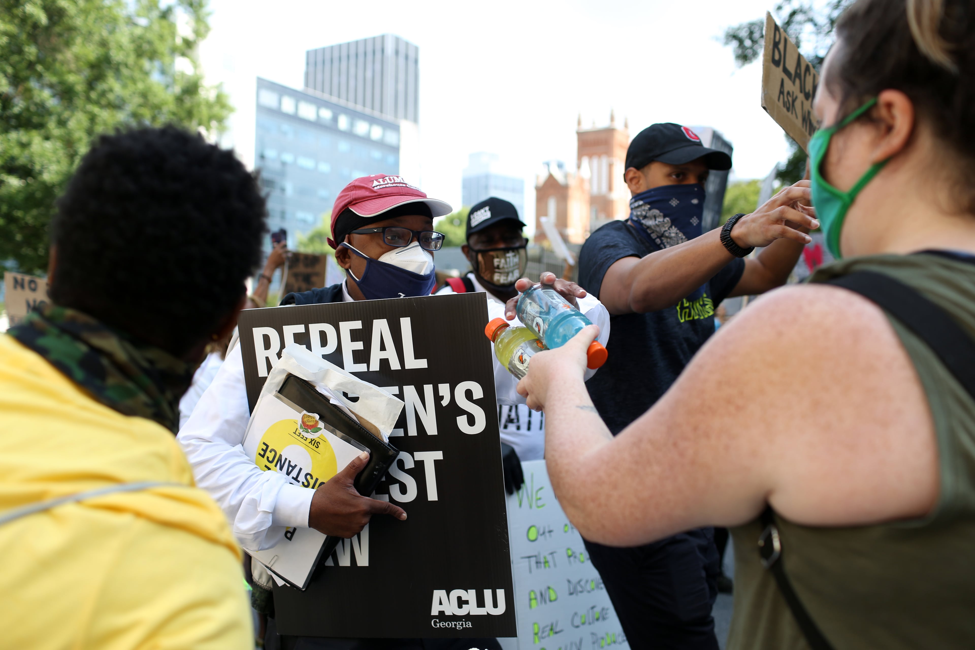 Volunteers give out gatorades to as protesters march from the Richard B. Russell Federal Building to the Georgia State Capitol in downtown Atlanta for March on Georgia, a protest hosted by the Georgia chapter for the NAACP, on Monday, June 15, 2020. (REBECCA WRIGHT FOR THE ATLANTA JOURNAL-CONSTITUTION)