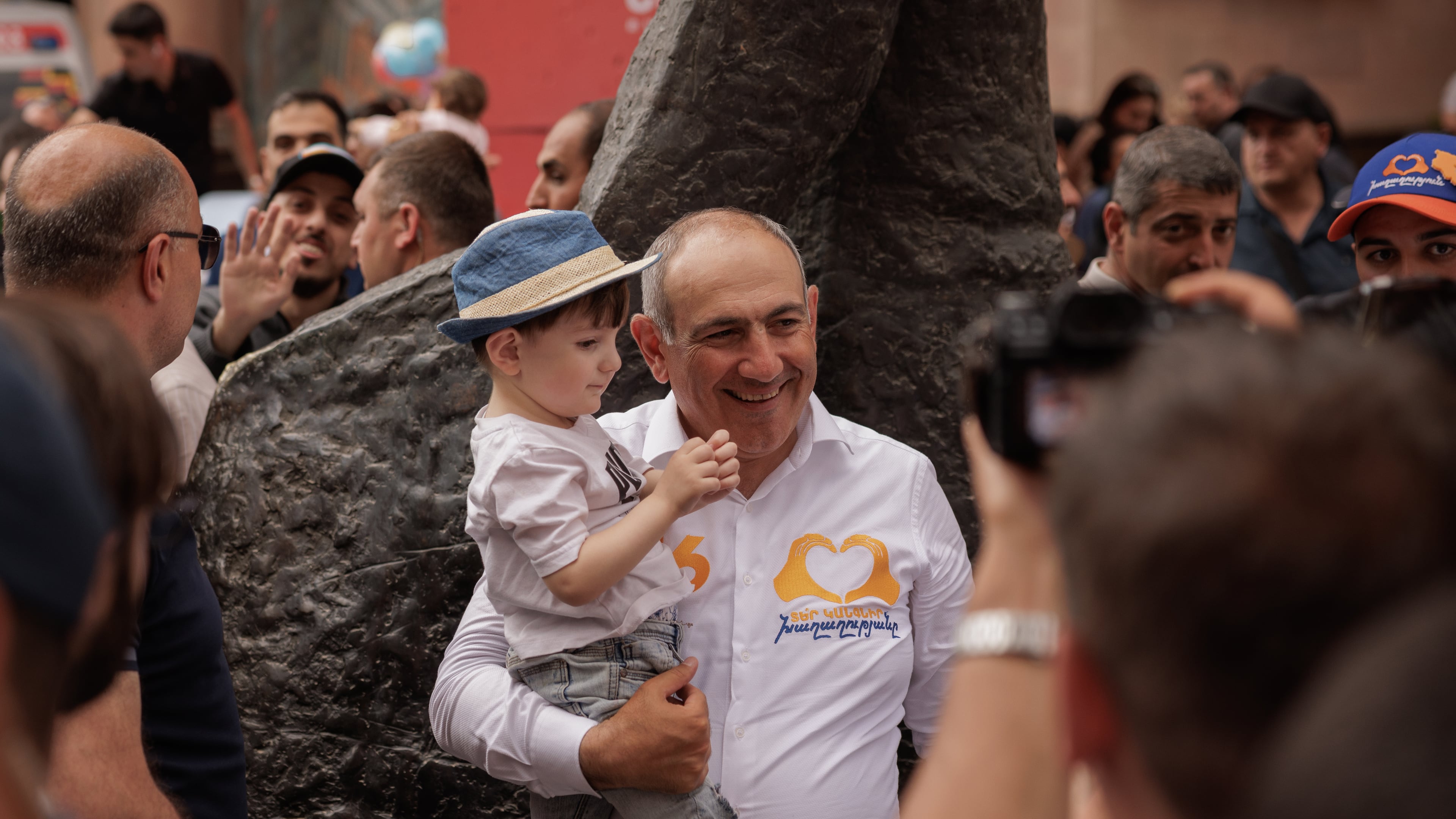 Armenian Prime Minister Nikol Pashinyan holds a child as he walks on Northern Avenue in Yerevan, Armenia, Monday, June 1, 2026, during public celebrations marking International Children's Day. (AP Photo/Anthony Pizzoferrato)