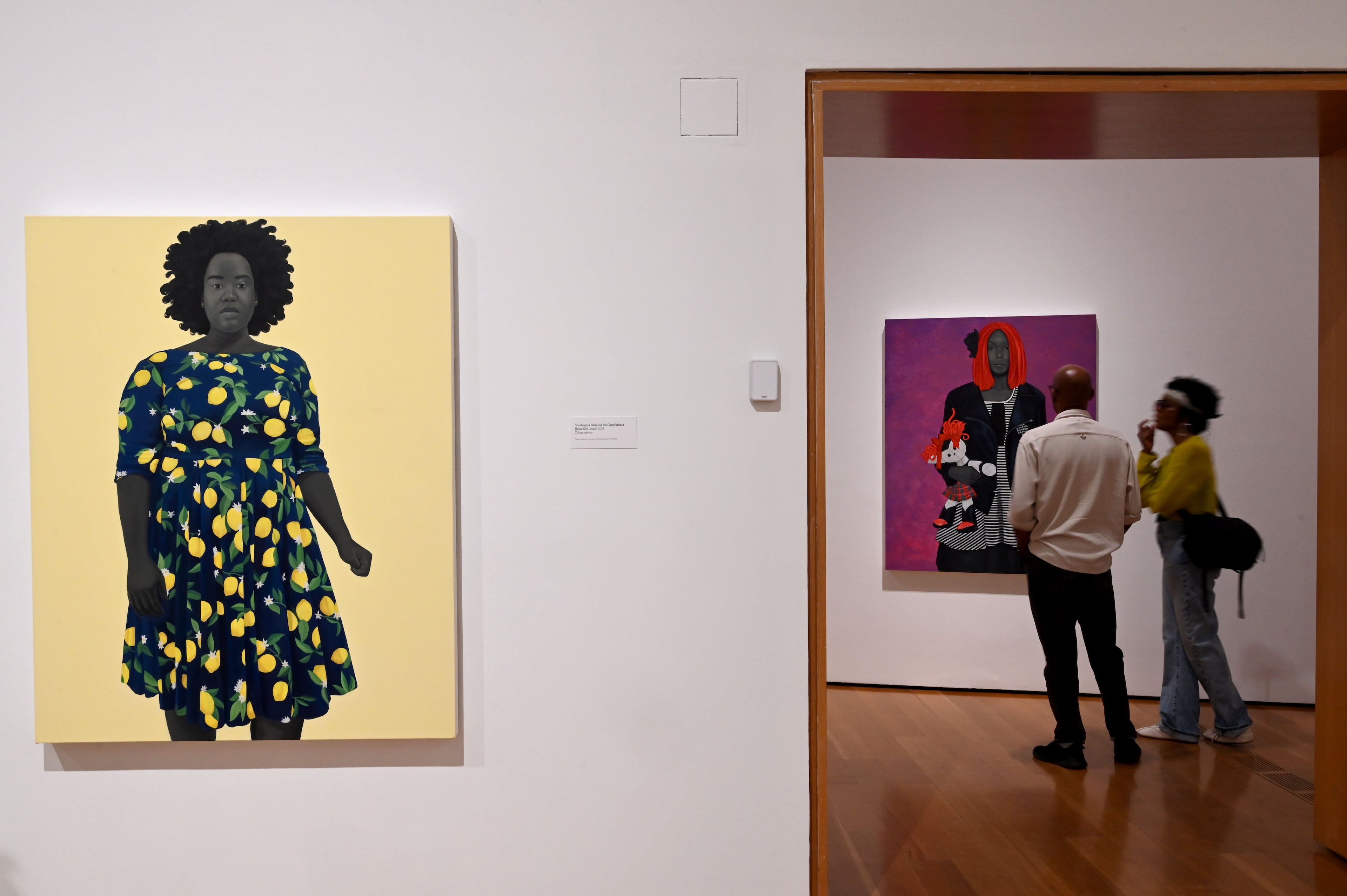 “She Always Believed the Good about Those She Loved” at left, is one of Amy Sherald's paintings on display at the High Museum — in the “American Sublime.” (Hyosub Shin/AJC)