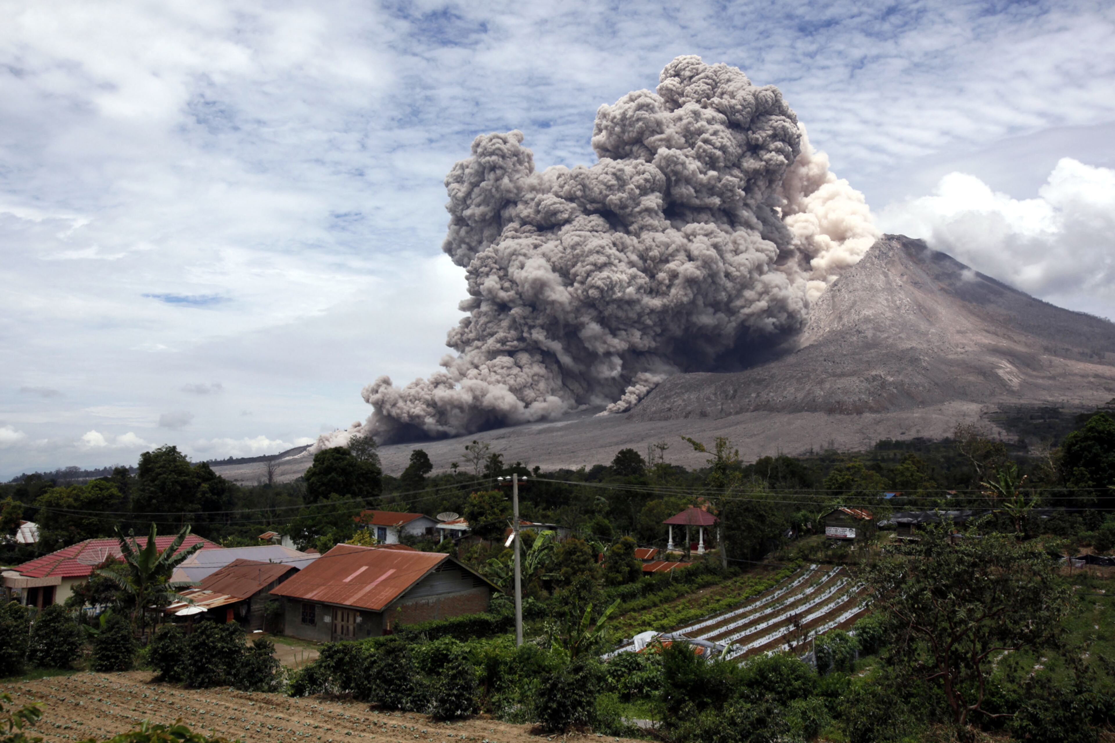 GOING WITH THE FLOW--Mount Sinabung releases pyroclastic flows seen from Tiga Serangkai, North Sumatra, Indonesia, Wednesday, April 1, 2015. Mount Sinabung, among about 130 active volcanoes in Indonesia, has sporadically erupted since 2010 after being dormant for more then 400 years. (AP Photo/Binsar Bakkara)