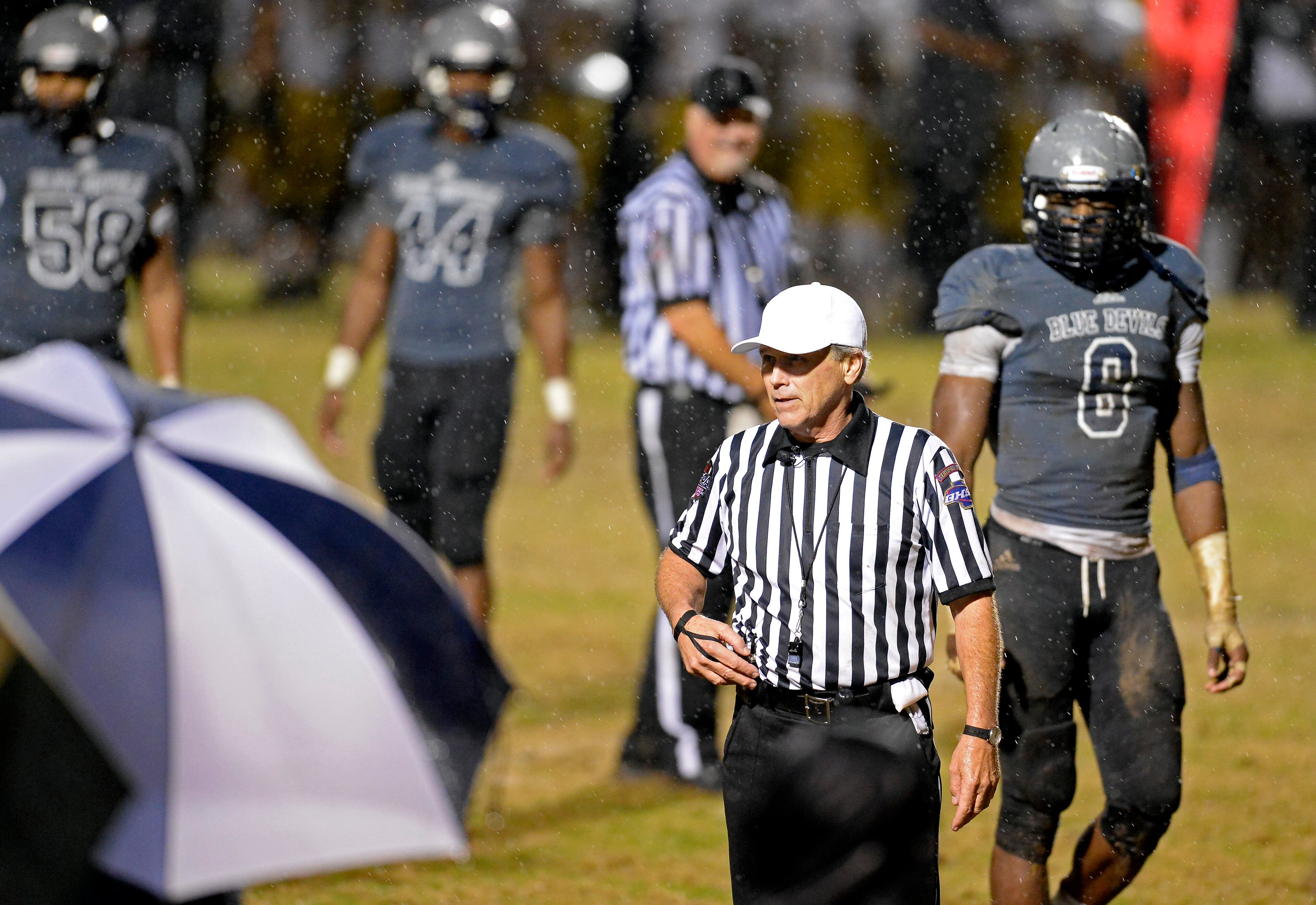 Norcross players walk off the field when referee Rusty Wynn calls for a lightning delay in the second half of the AAAAAA semifinal game against Colquitt County at Blue Devil Stadium on Friday, Dec. 6, 2013, in Norcross, Ga.