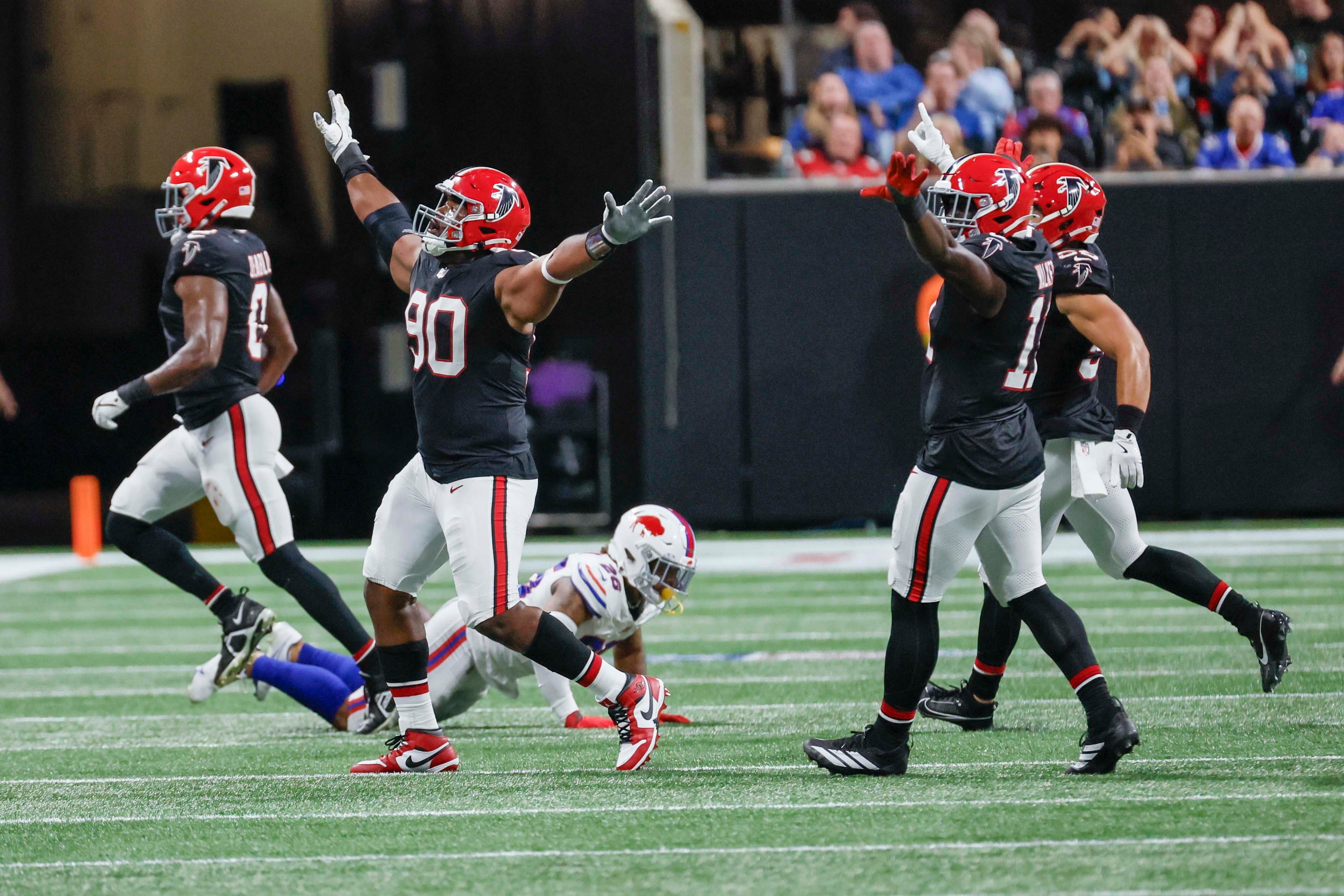 Atlanta Falcons defensive tackle David Onyemata (90) reacts with temmates after stopping the Buffalo Bill on a fourth down during the second half of an NFL football game against the Buffalo Bills at Mercedes-Benz Stadium in Atlanta on Monday, October 13, 2025. (Miguel Martinez/ AJC)