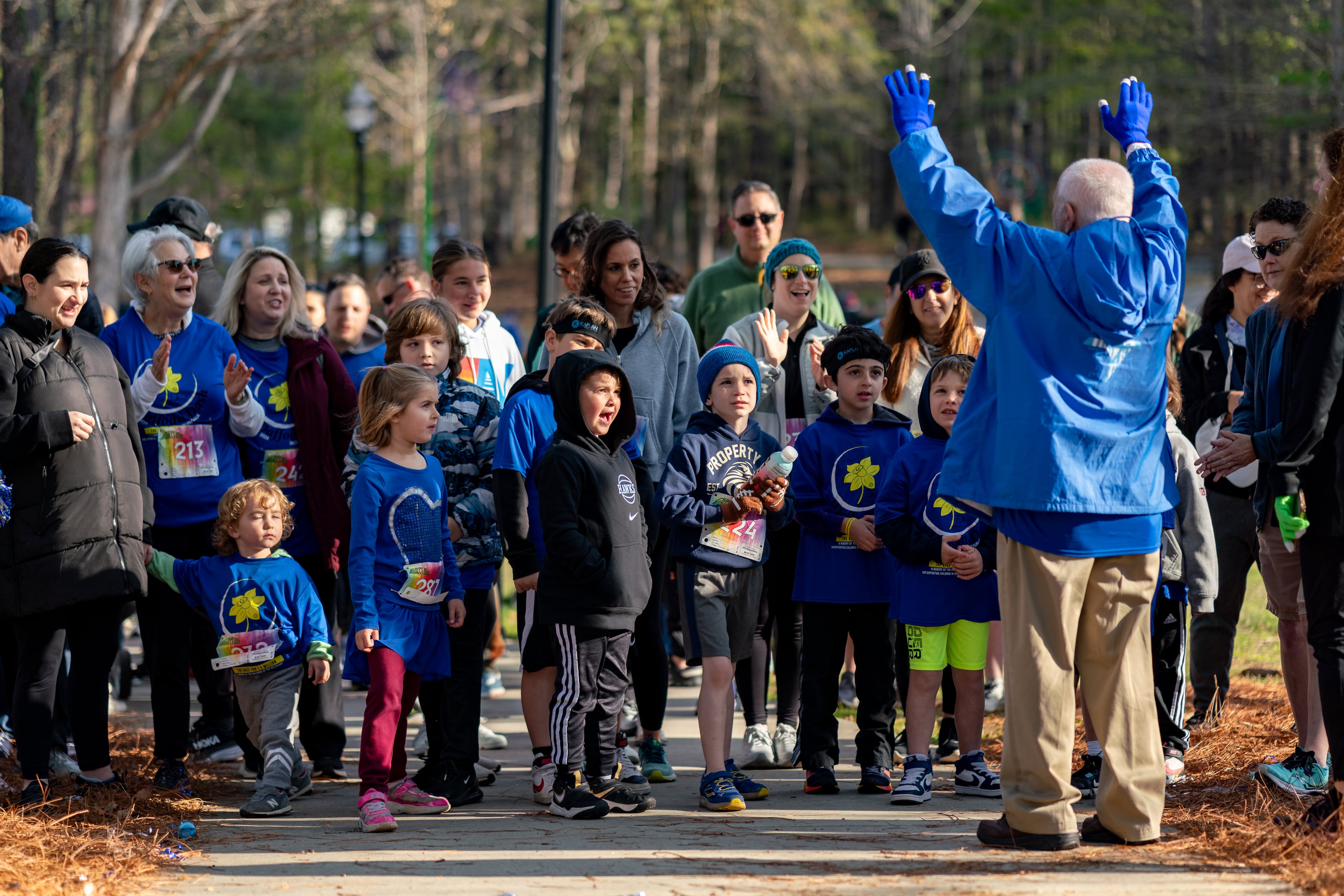 Hershel Greenblat speaks to the crowd before the kids' 1k race starts at the Daffodil Dash AT Brook Run Park in Dunwoody on Sunday, April 7, 2024. (Ben Hendren for The Atlanta Journal-Constitution)