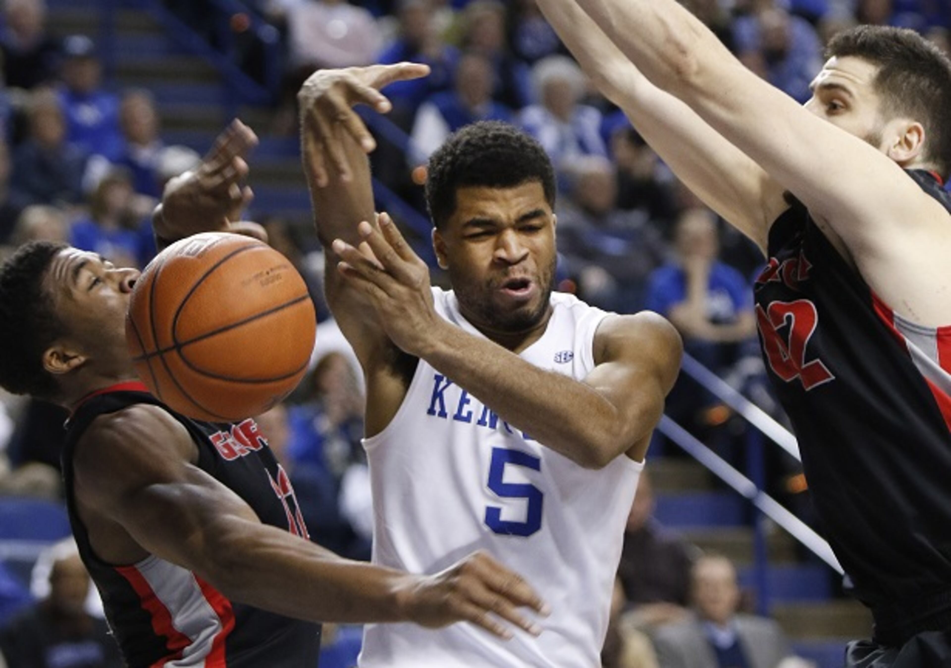 Kentucky's Andrew Harrison (5) loses the ball between Georgia's Kenny Gaines, left, and Nemanja Djurisic during the second half of an NCAA college basketball game, Tuesday, Feb. 3, 2015, in Lexington, Ky. Kentucky won 69-58. (AP Photo/James Crisp) Could Georgia be the team that topples unbeaten UK? (James Crisp/AP photo)