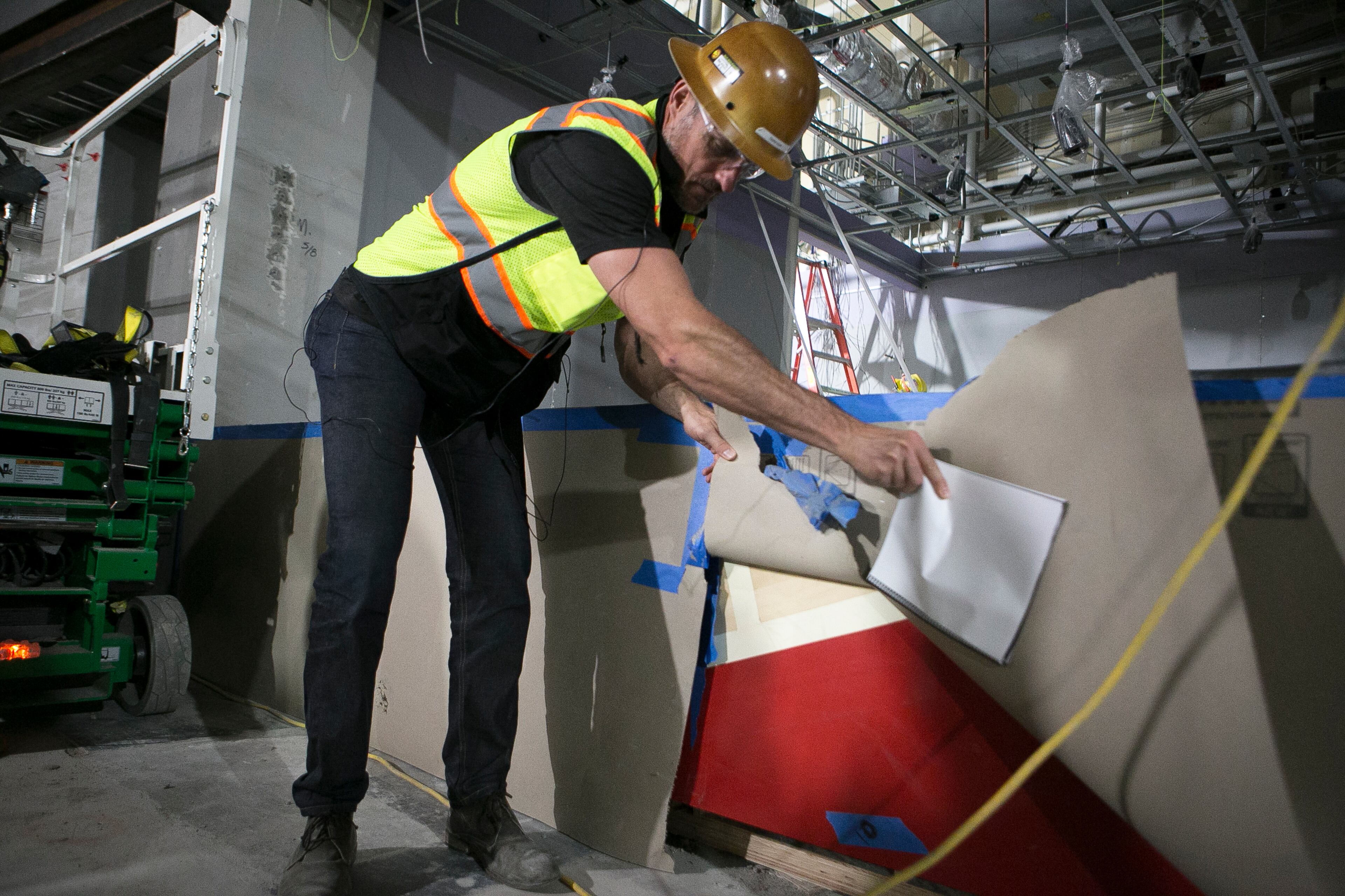 Brett Stefansson, Atlanta Hawks executive vice president and general manager of State Farm Arena, shows the front of a bar made with wood from the old court in the Players Club area during a guided media tour through the in-progress renovations at the State Farm Arena in Atlanta, Ga., on Thurs., Sept. 20, 2018. The renovations, which total $192.5 million, are on track to be completed by the arena's scheduled open house on October 20. The current rate of progress is about $1 million of work per day, according to Stefansson. (CASEY SYKES, CASEYLANESYKES@GMAIL.COM)