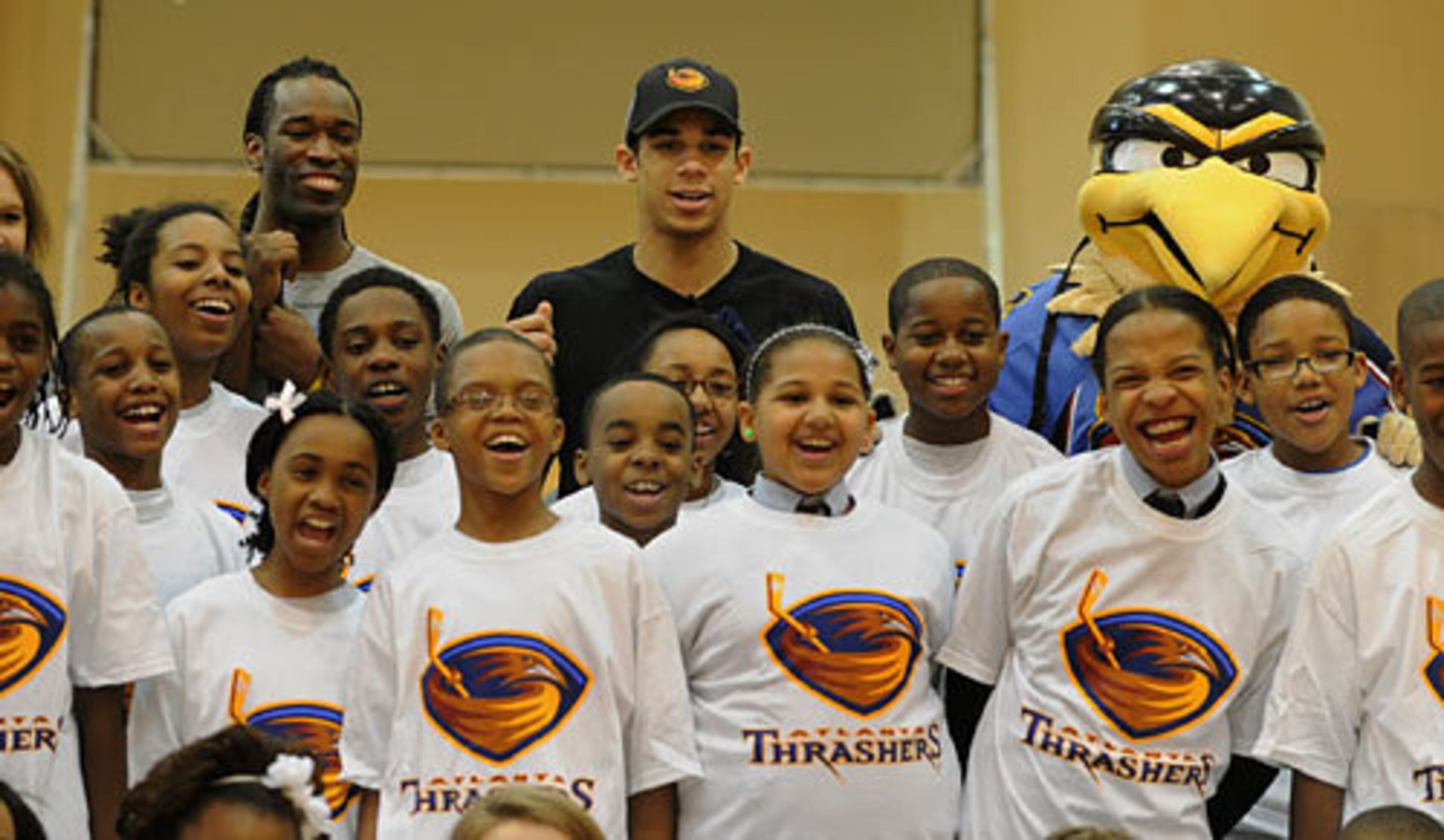 Evander Kane (center) takes a group picture during his Everyone Clinic with students from the Ron Clark Academy inside the gym at Mount Pleasant Baptist Church.