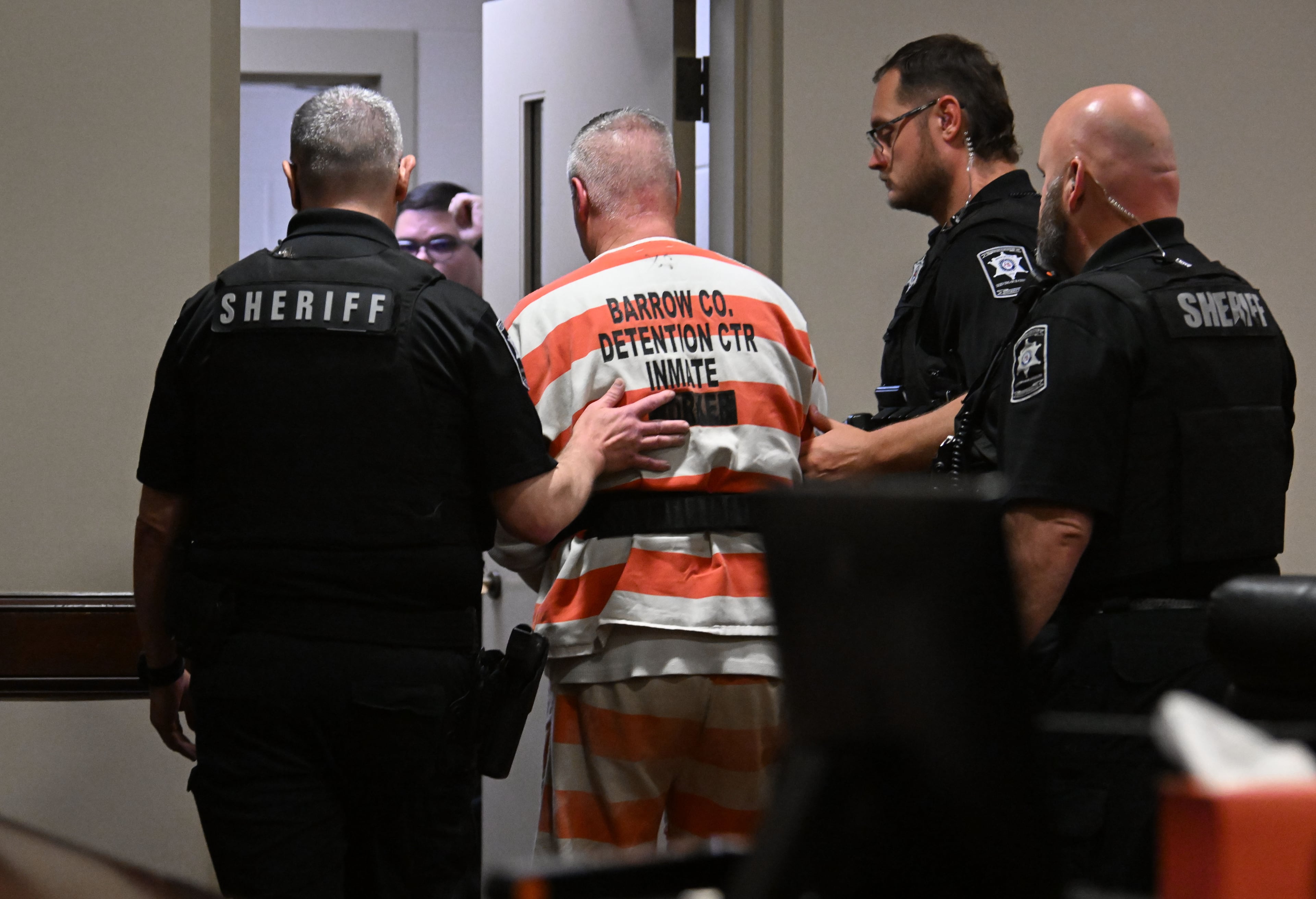 Colin Gray is escorted in handcuffs out of the courtroom after sentencing at Barrow County Superior Court in Winder on Thursday, July 30, 2026. Gray was sentenced Thursday to 15 years in prison two days after his son was sentenced to life in prison without the possibility of parole for Georgia’s deadliest school shooting. (Hyosub Shin/AJC)