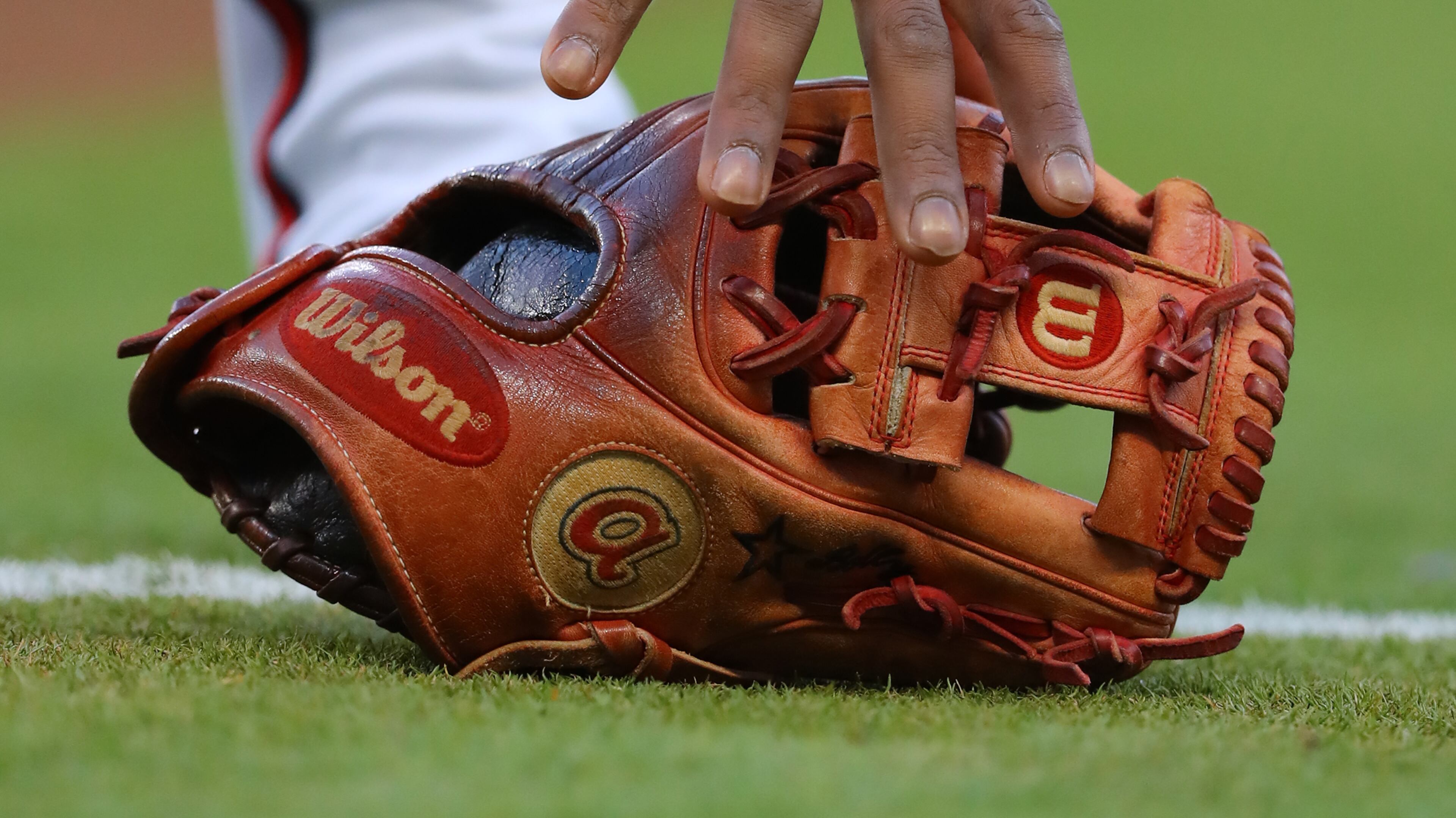 Atlanta Braves second baseman Ozzie Albies grabs his glove.