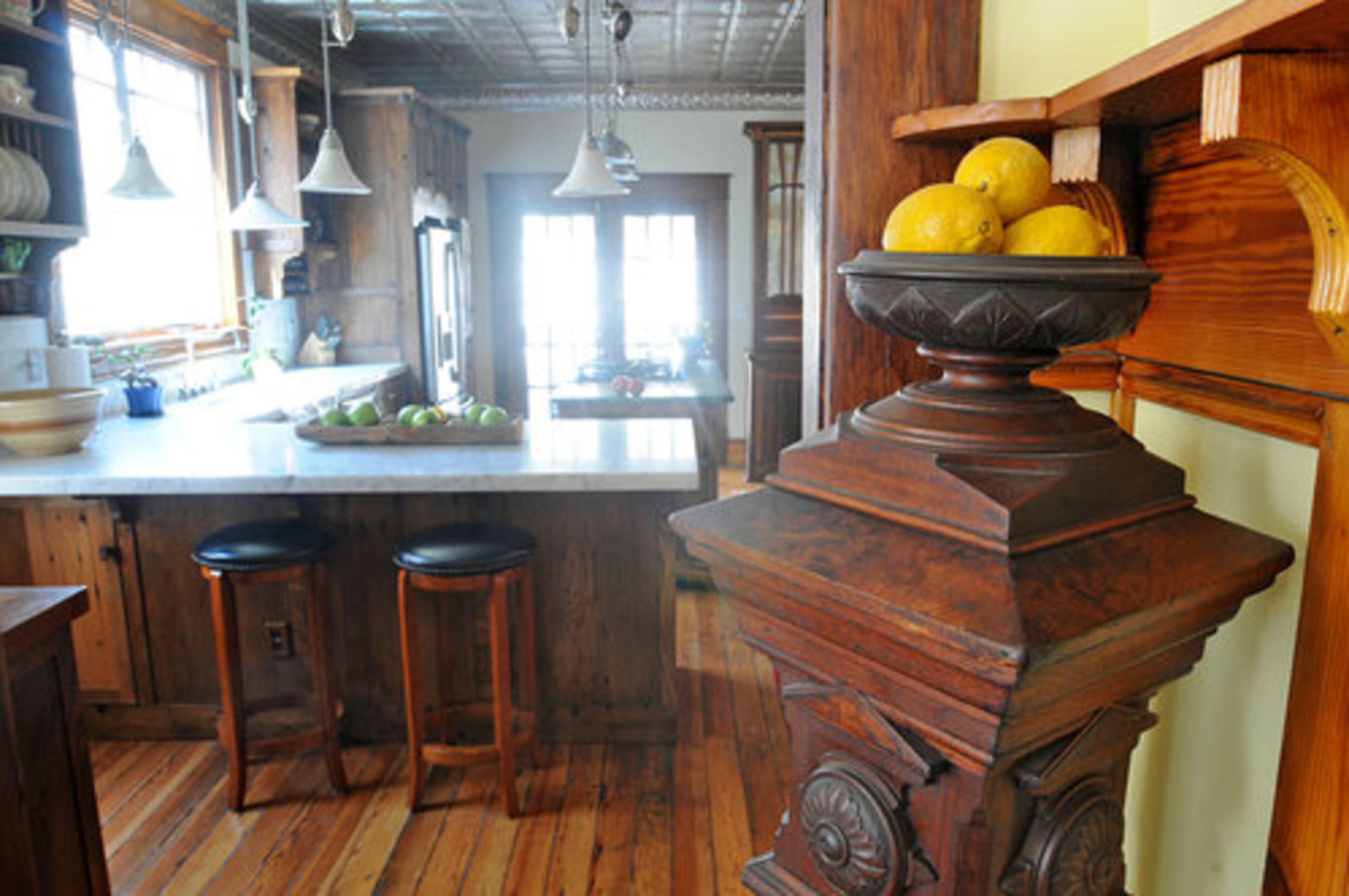 The intricate walnut newel post in the photo is part of a collection of newel posts found in the house. This one came from a New York City brownstone," said Kara O'Brien.
