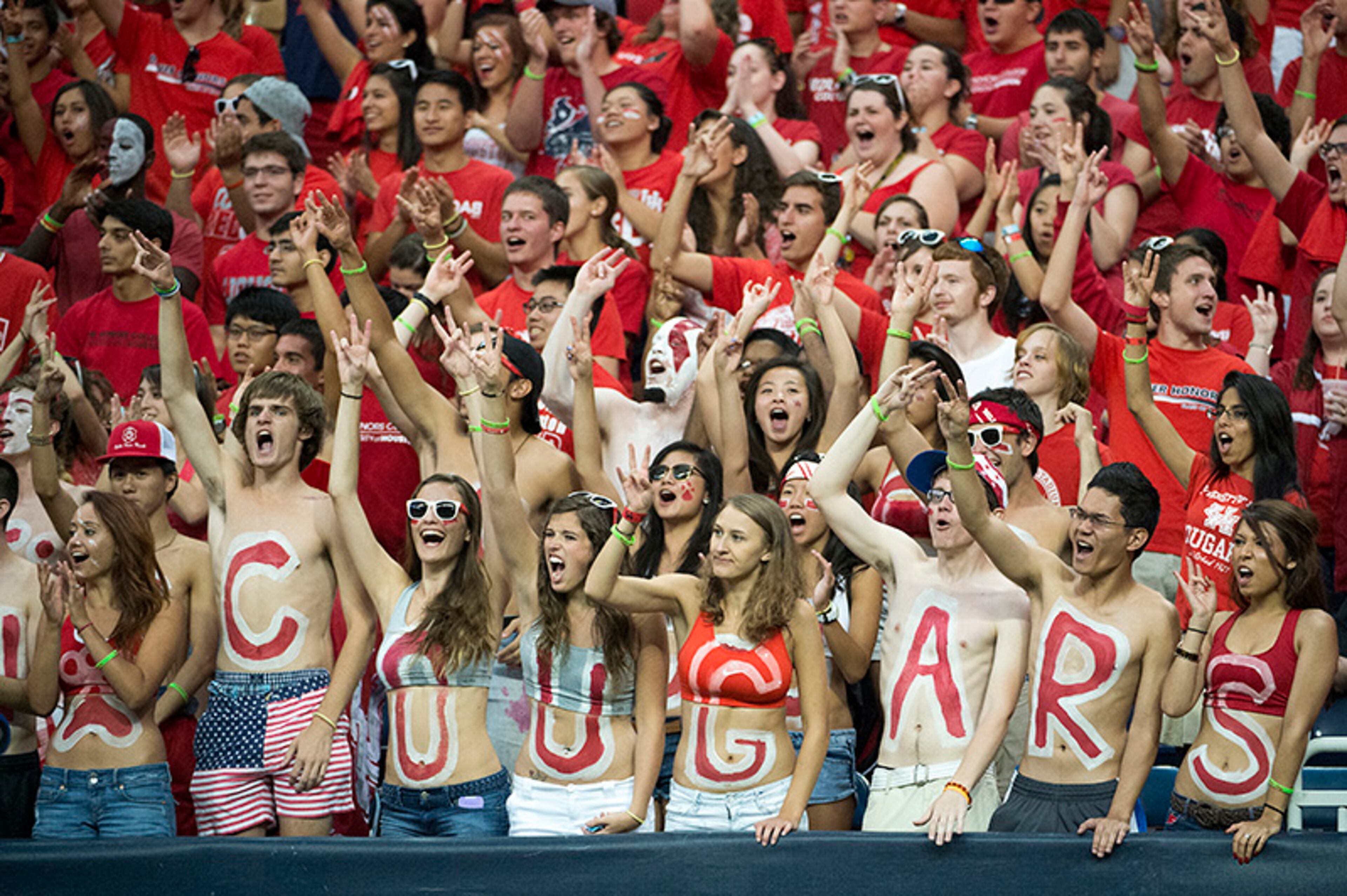 Houston fans cheer as their team takes on Southern during the first half of an NCAA college football game on Friday, Aug. 30, 2013, in Houston.