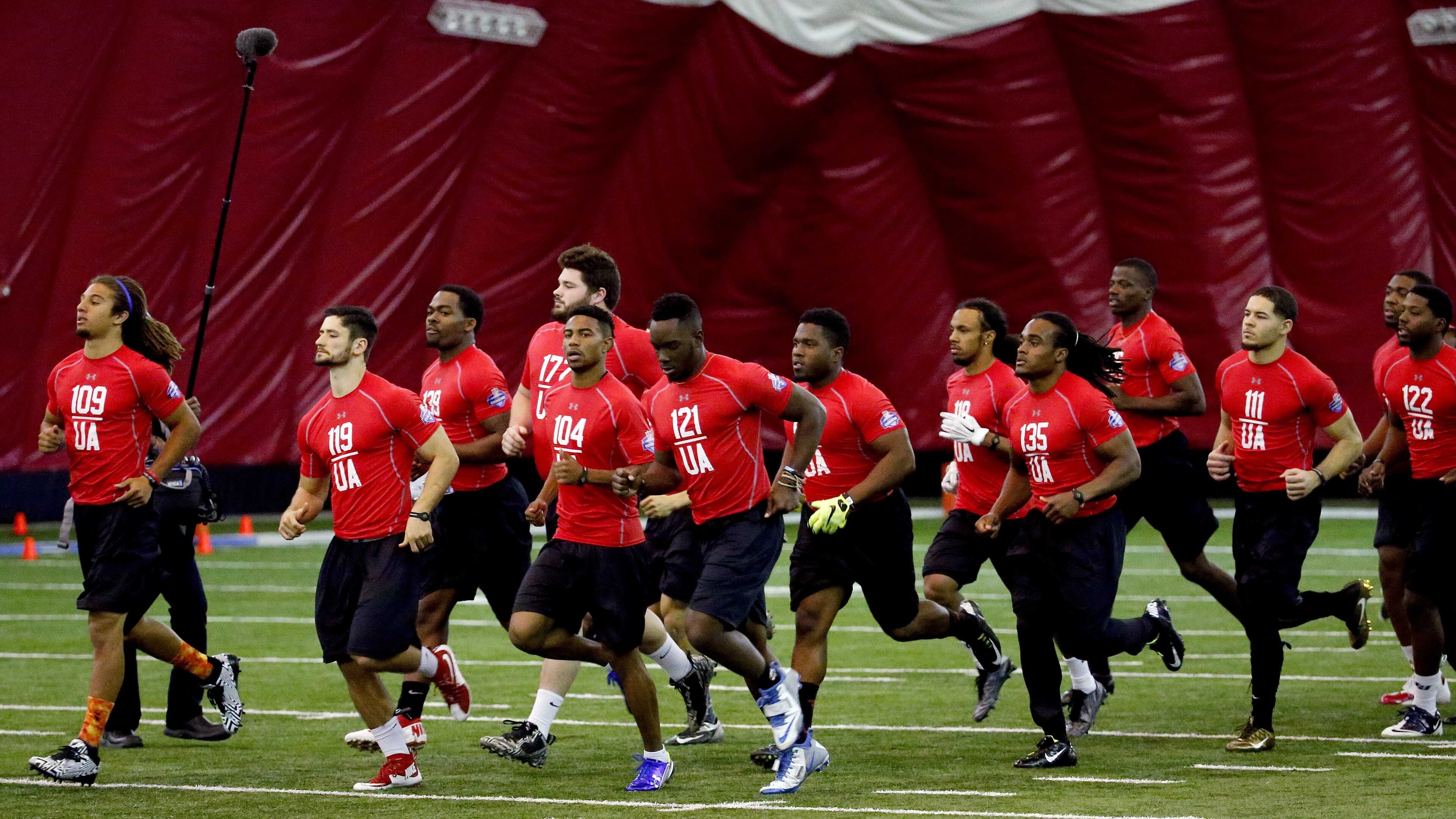 Collegiate players run drills during a regional NFL football combine, Saturday, Feb. 20, 2016, in Tempe, Ariz. (AP Photo/Matt York)