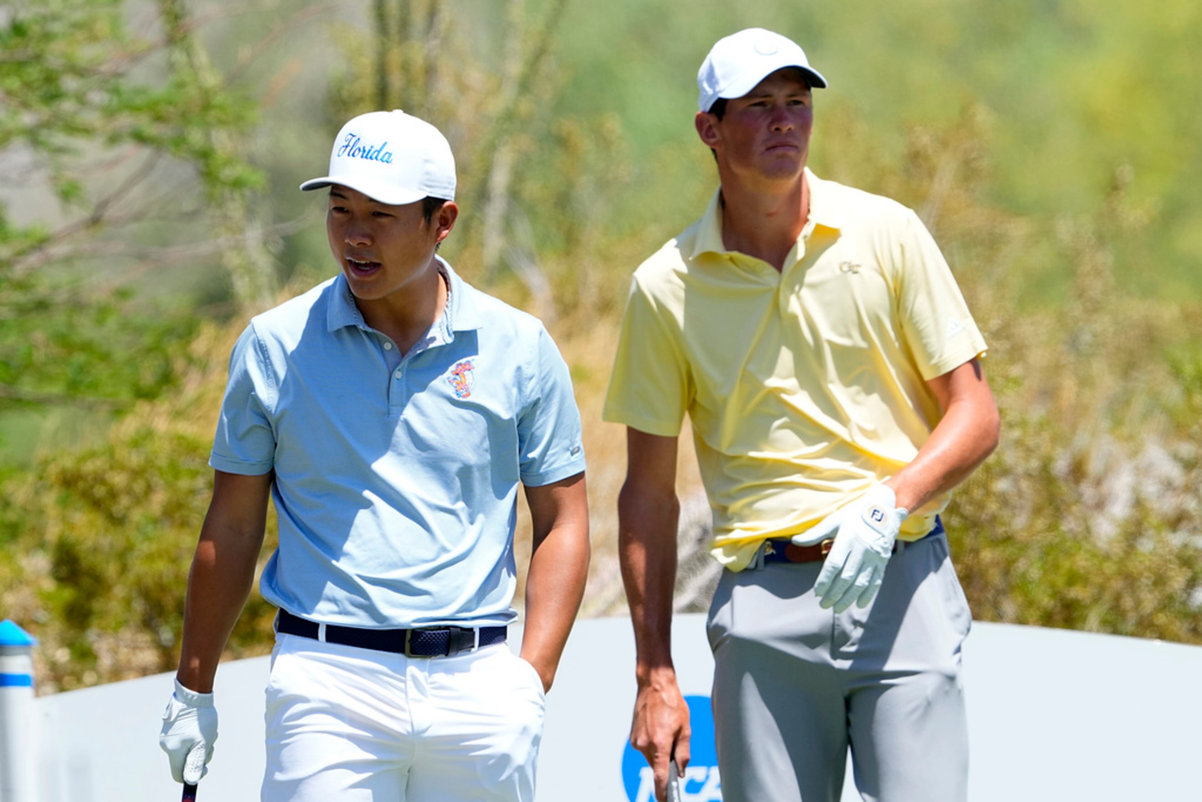 Florida golfer Yuxin Lin, left, and Georgia Tech golfer Christo Lamprecht wait to hit from the first tee during the final round of the NCAA college men's match play golf championship, Wednesday, May 31, 2023, in Scottsdale, Ariz. (AP Photo/Matt York)