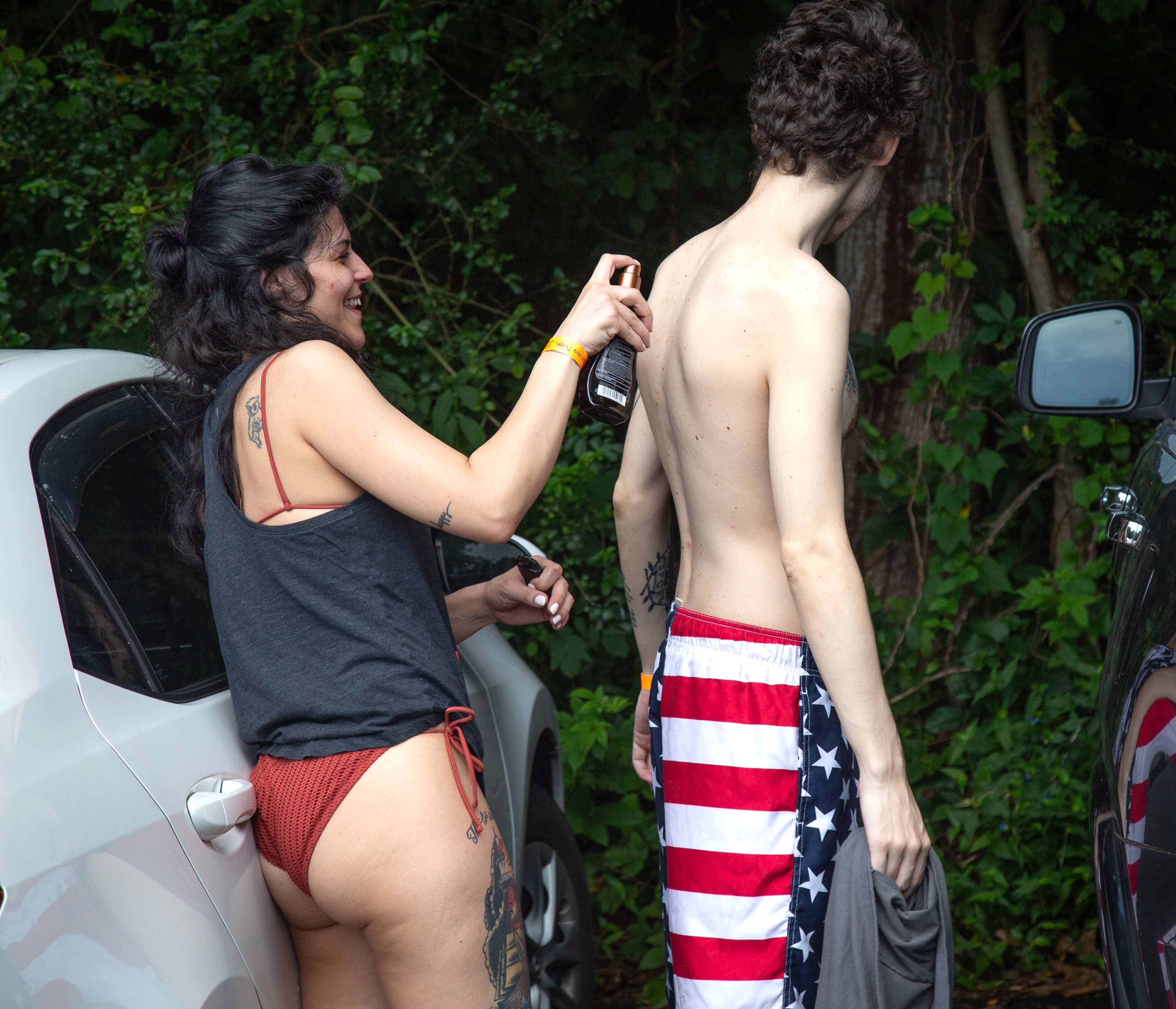 Stephanie Graulich applies suntan lotion to John Hansen before they head to the Chattahoochee River for a day of tubing at the Powers Island Park in Sandy Springs on Sunday, June 28, 2020. STEVE SCHAEFER FOR THE ATLANTA JOURNAL-CONSTITUTION