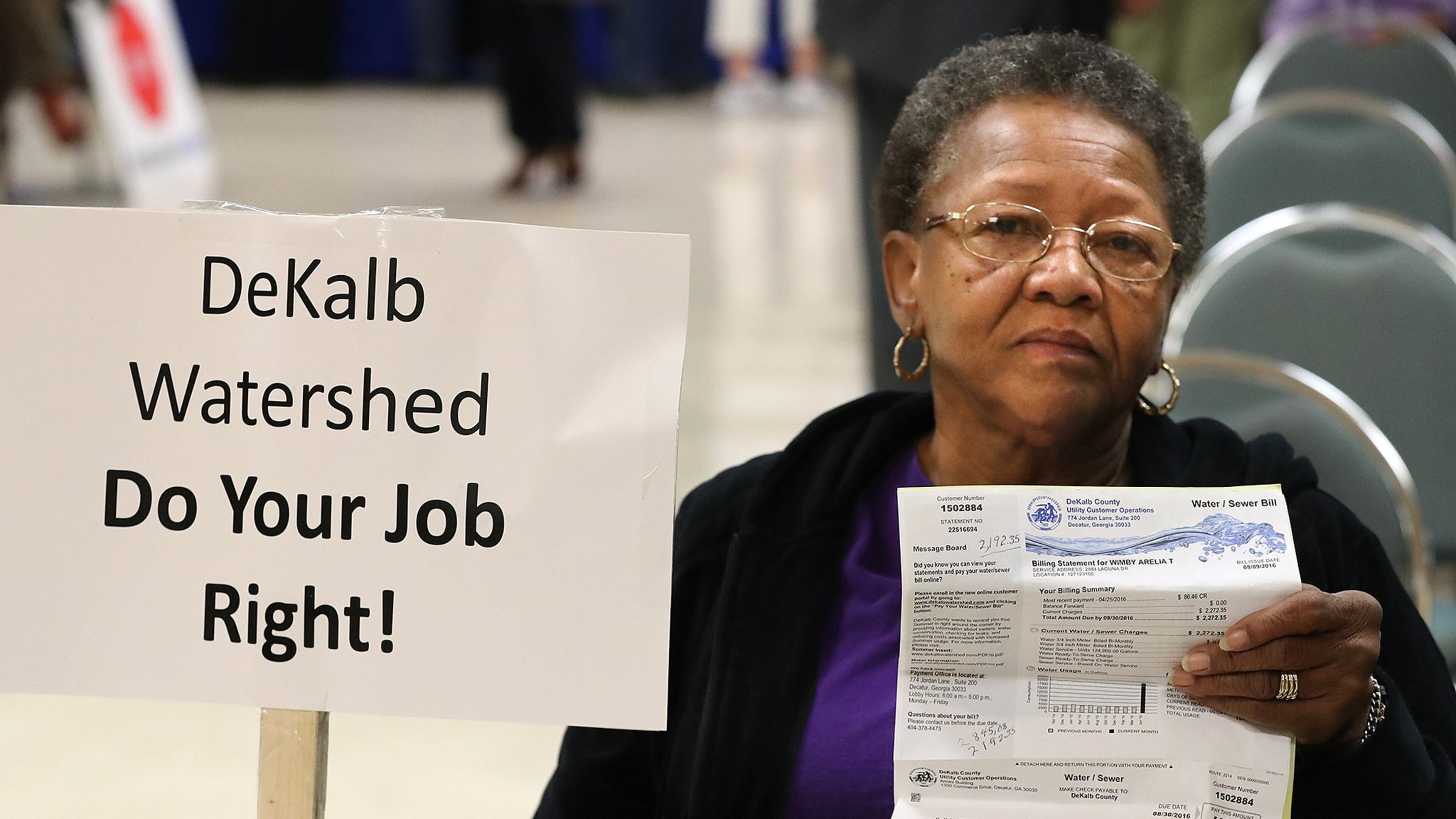 DeKalb resident Arelia Wimby, whose latest water bill is $2,845.08, was on hand with dozens of other area residents to demand answers about excessively high water bills during a town hall meeting at the Maloof Auditorium in Decatur on Nov. 10. Curtis Compton/ccompton@ajc.com