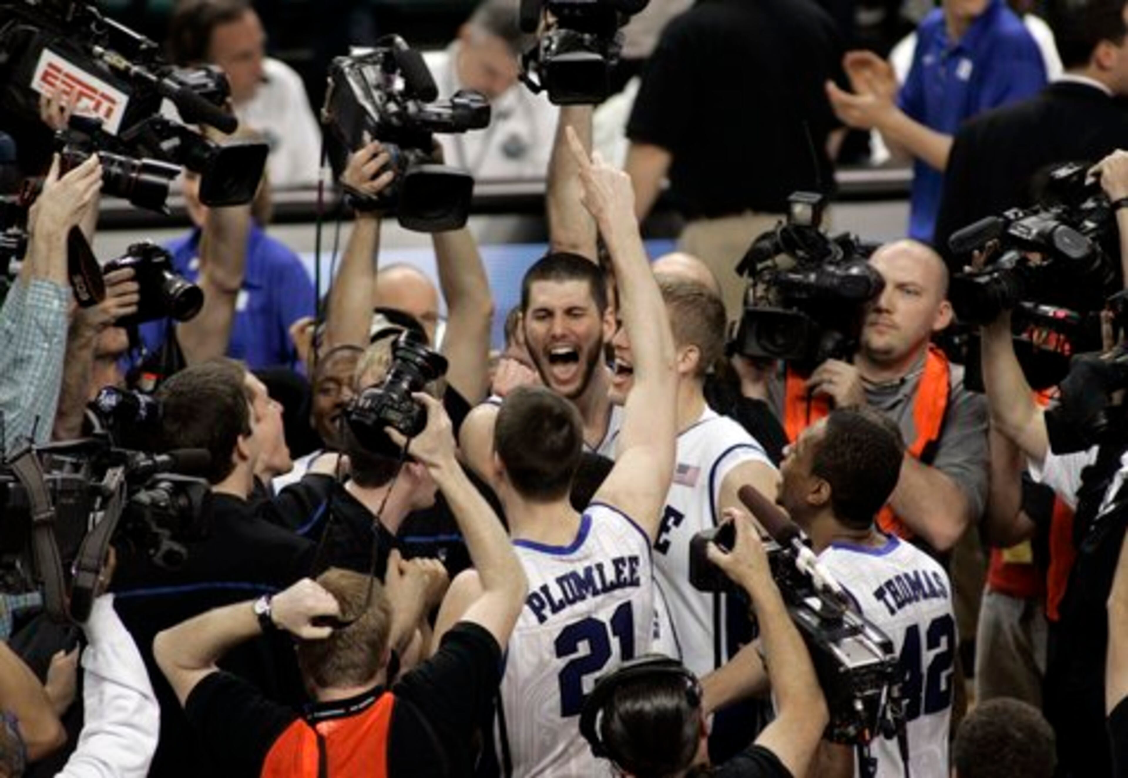 Duke's Brian Zoubek, center, reacts with teammates after an NCAA college basketball game with Georgia Tech in the Atlantic Coast Conference tournament in Greensboro, N.C., Sunday, March 14, 2010. Duke won 65-61.