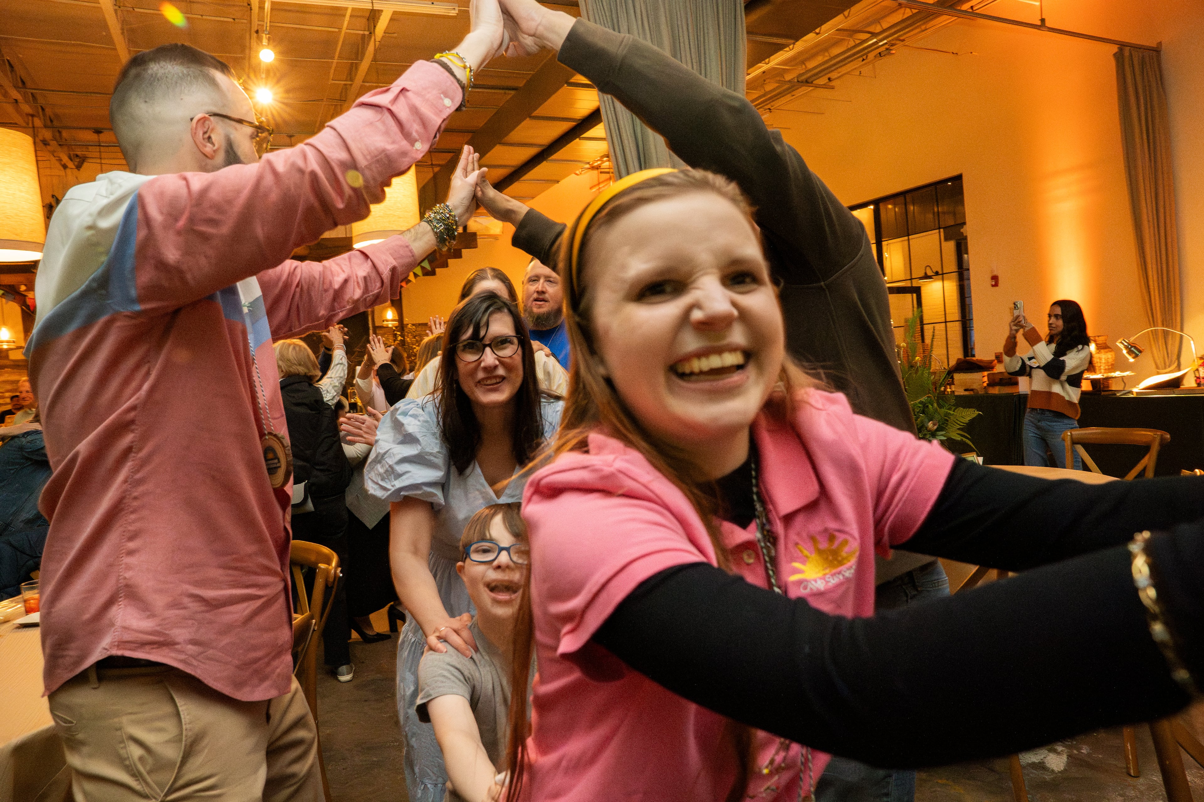Attendees start a conga line during the variety show at the Sunshine Spectacular dinner fundraiser in Atlanta on Sunday, March. 9, 2025. (Olivia Bowdoin for the AJC).