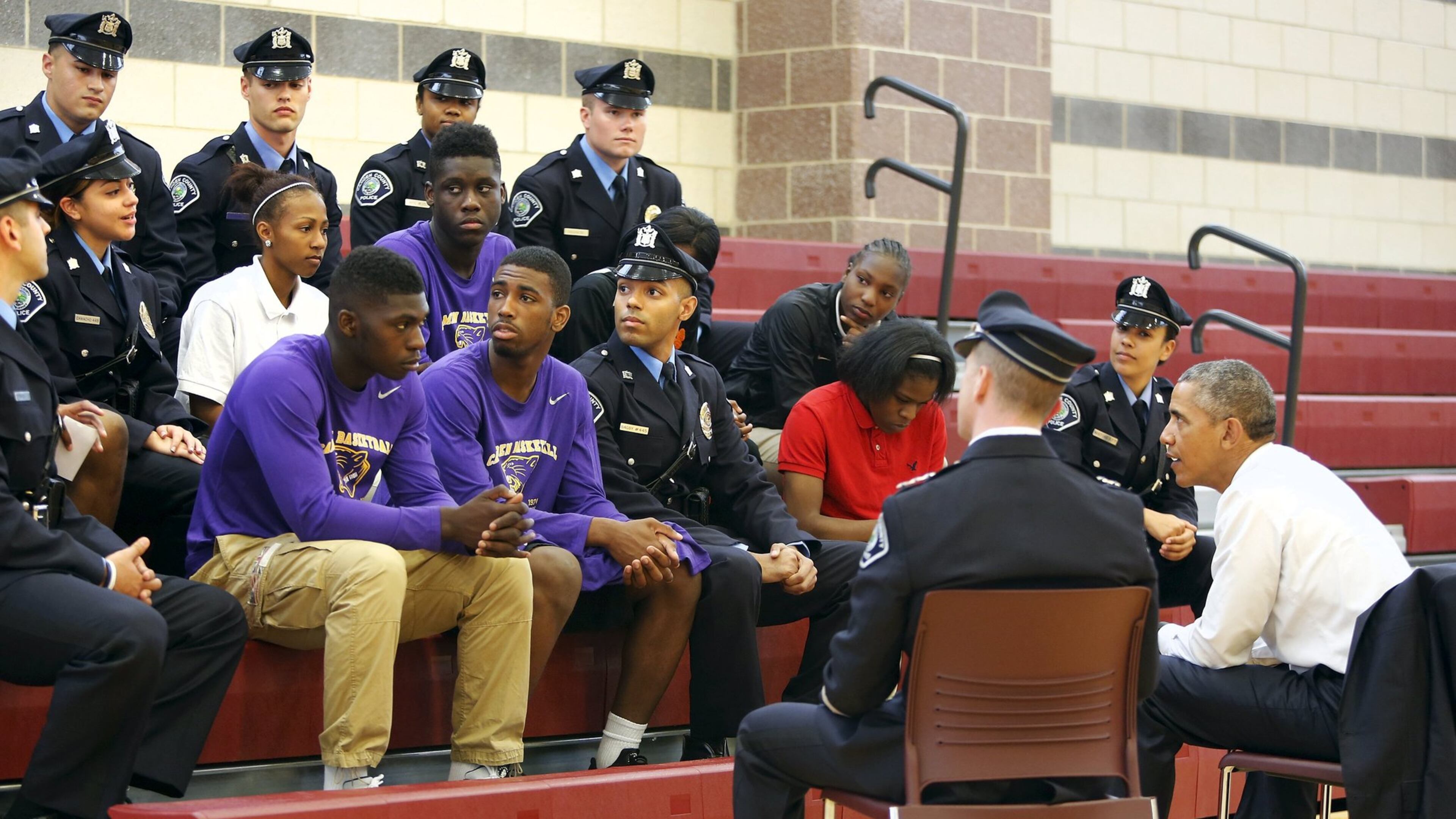 Then-President Barack Obama meets with students and law enforcement officers at the Ray and Joan Kroc Corps Community Center in Camden, New Jersey May 18, 2015. Obama was making the visit with law enforcement officials Monday to push efforts to encourage trust-building between police and the communities they serve. REUTERS/Jonathan Ernst
