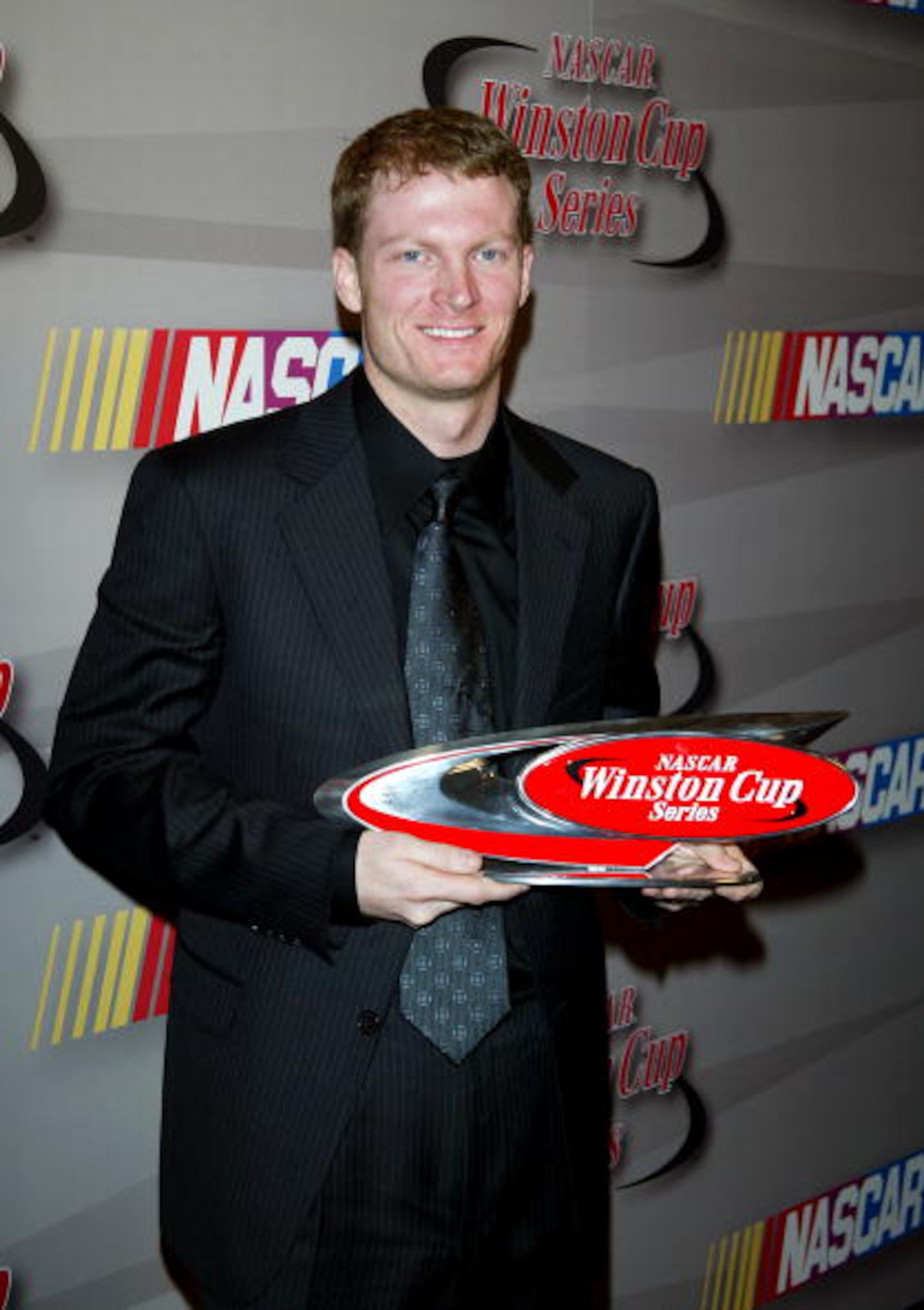 NEW YORK - DECEMBER 05: NASCAR driver Dale Earnhardt Jr. poses with 3rd place trophy in the press room during the 2003 NASCAR Winston Cup Awards at the Waldorf Astoria Hotel December 05, 2003 in New York City. (Photo by Matthew Peyton/Getty Images)