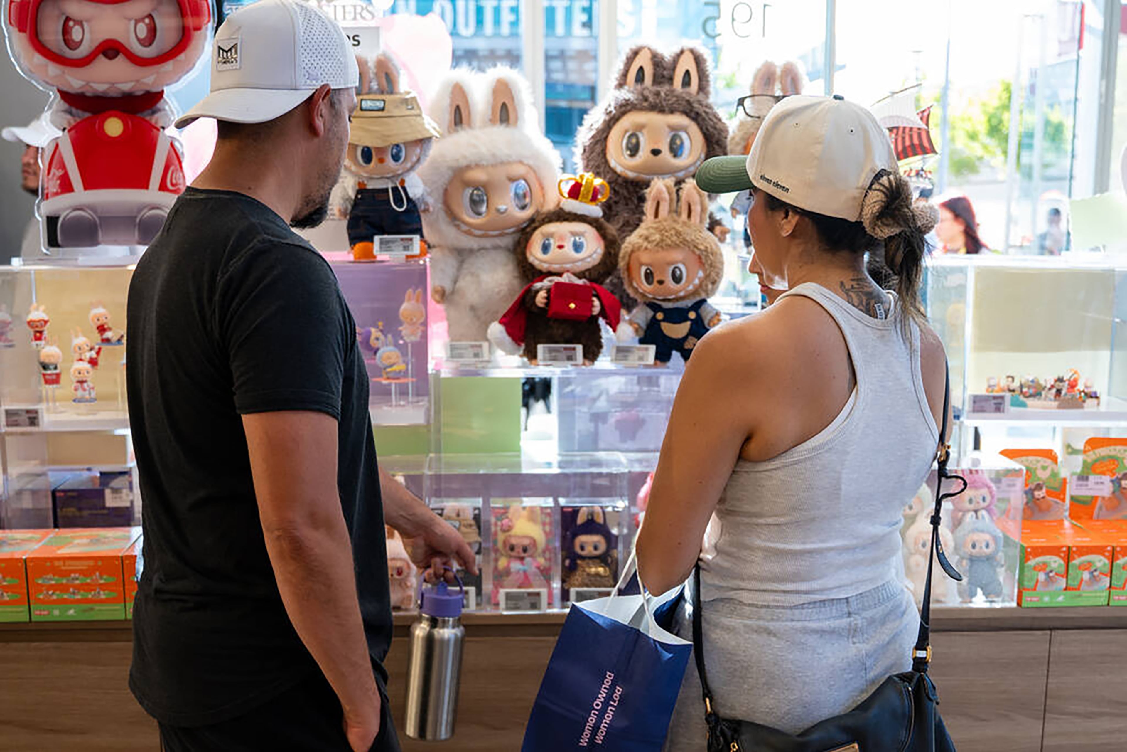 Customers check out Labubu dolls at Pop Mart's new store in Las Vegas. The grand opening drew hundreds, some of whom waited overnight, eager to purchase the popular collectibles, which are often sold out online or resold at marked-up prices. (Kara Gildea/Las Vegas Review-Journal/TNS)