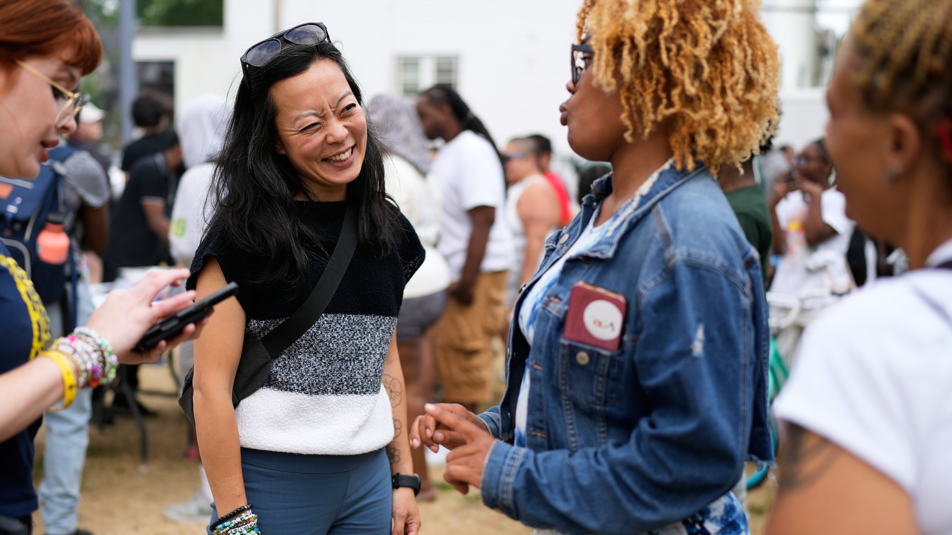 Democratic gubernatorial candidate Francesca Hong talks with Milwaukee residents during "We Outside" Annual Community Event at Metcalfe Park Rising, Friday, July 24, 2026, in Milwaukee. (AP Photo/Nam Y. Huh)