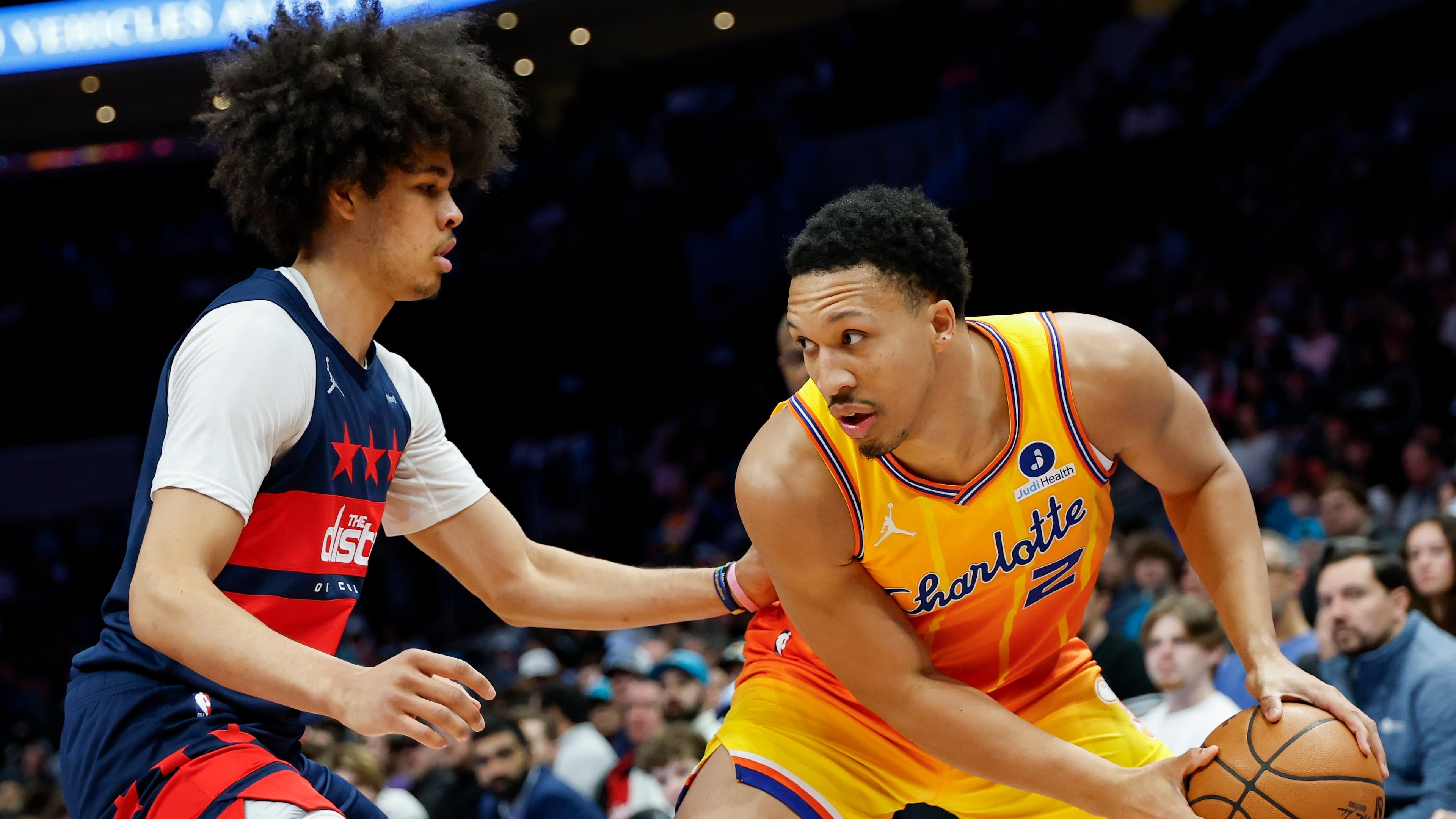 Charlotte Hornets forward Grant Williams (2) looks to drive against Washington Wizards guard Kyshawn George during the first half of an NBA basketball game in Charlotte, N.C., Saturday, Jan. 24, 2026. (AP Photo/Nell Redmond).