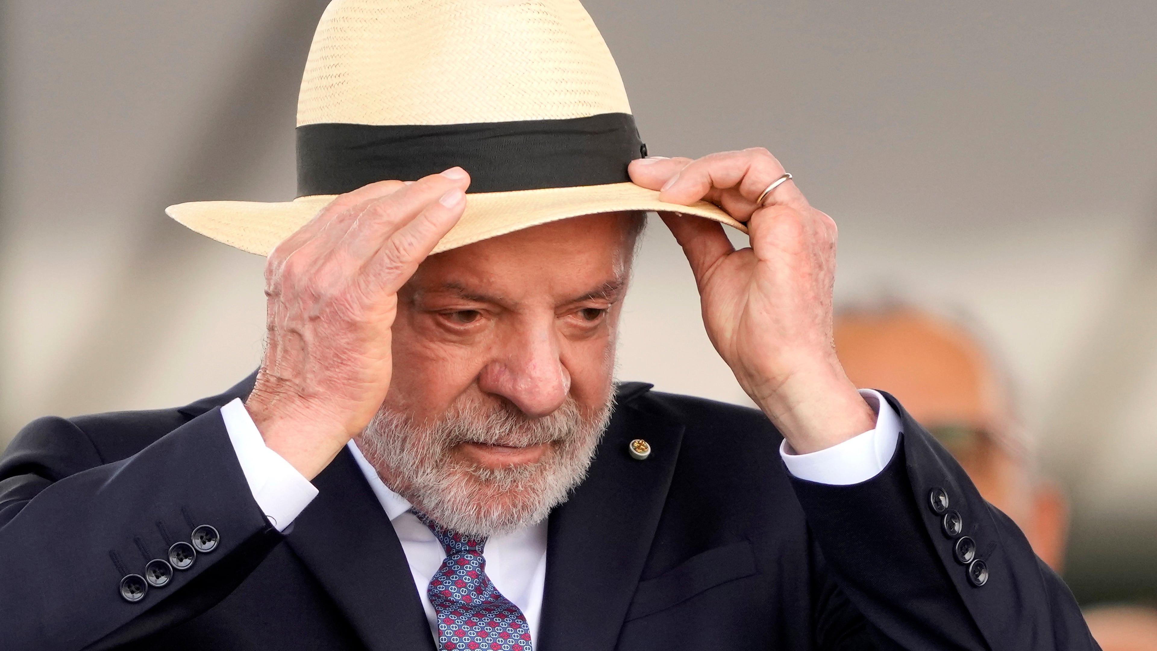 Brazilian President Luiz Inacio Lula da Silva adjusts his hat during a Soldier's Day ceremony at Army headquarters in Brasilia, Brazil, Tuesday, Aug. 25, 2026. (AP Photo/Eraldo Peres)