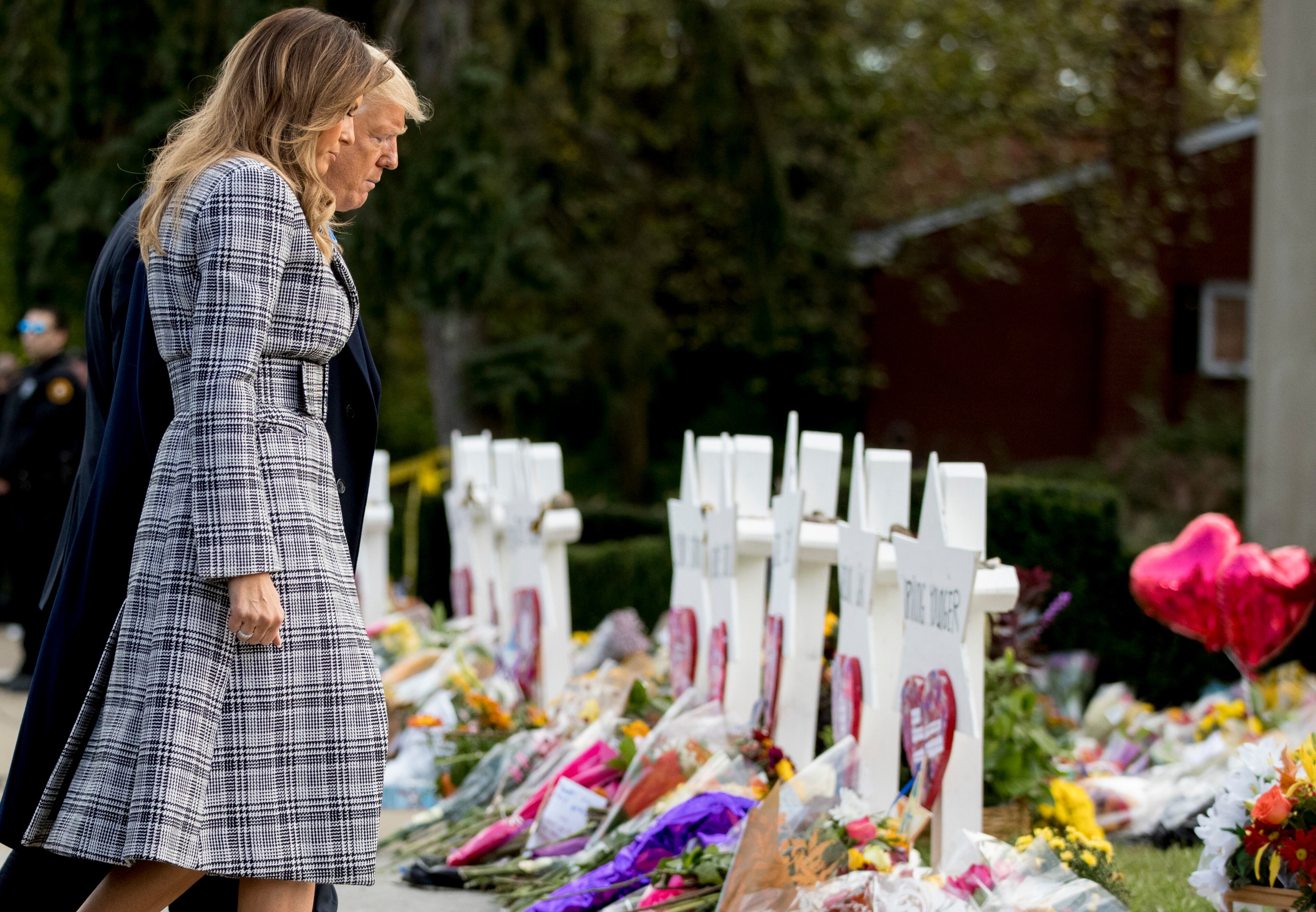 President Donald Trump and first lady Melania Trump walk past a memorial outside Pittsburgh's Tree of Life Synagogue in Pittsburgh, Tuesday, Oct. 30, 2018. (AP Photo/Andrew Harnik)