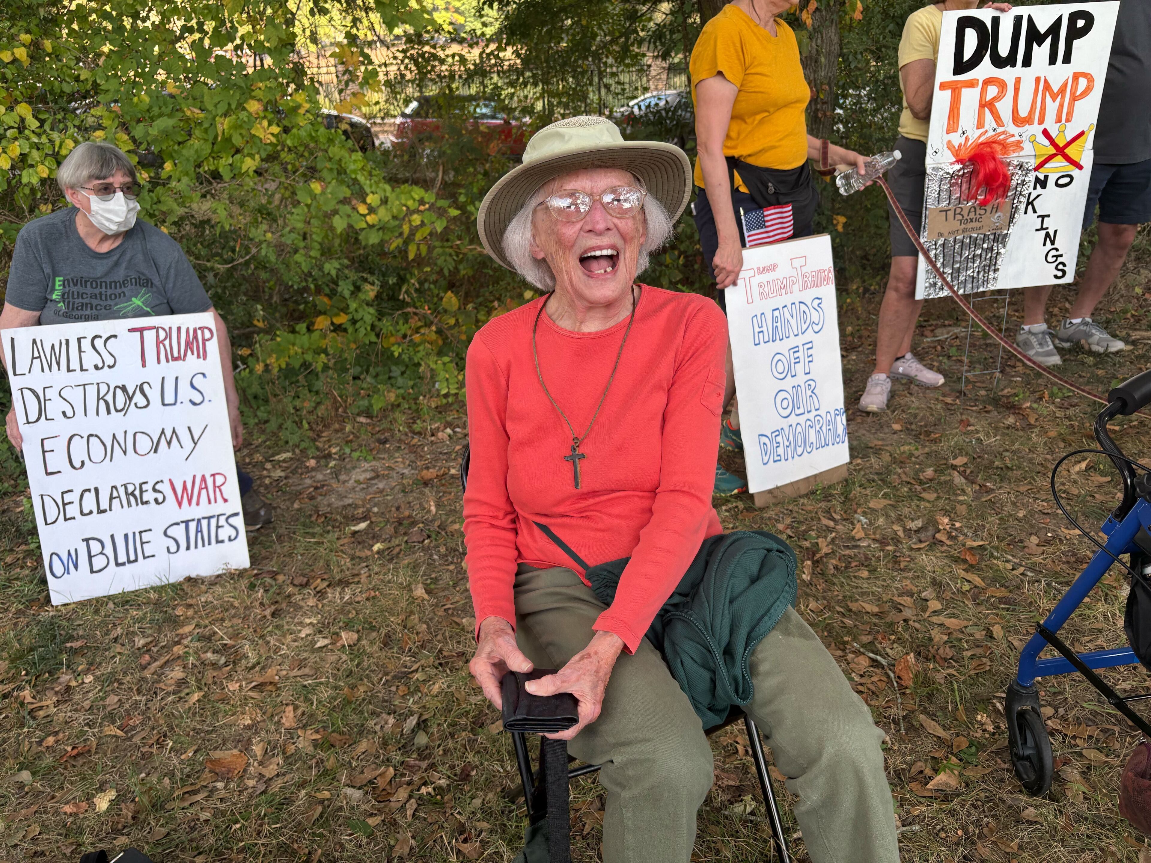 Suzanne Goodell, 102, was among a large group of DeKalb County seniors who lined Clairmont Road on Saturday to protest President Donald Trump and his administration. (Shaddi Abusaid/AJC)