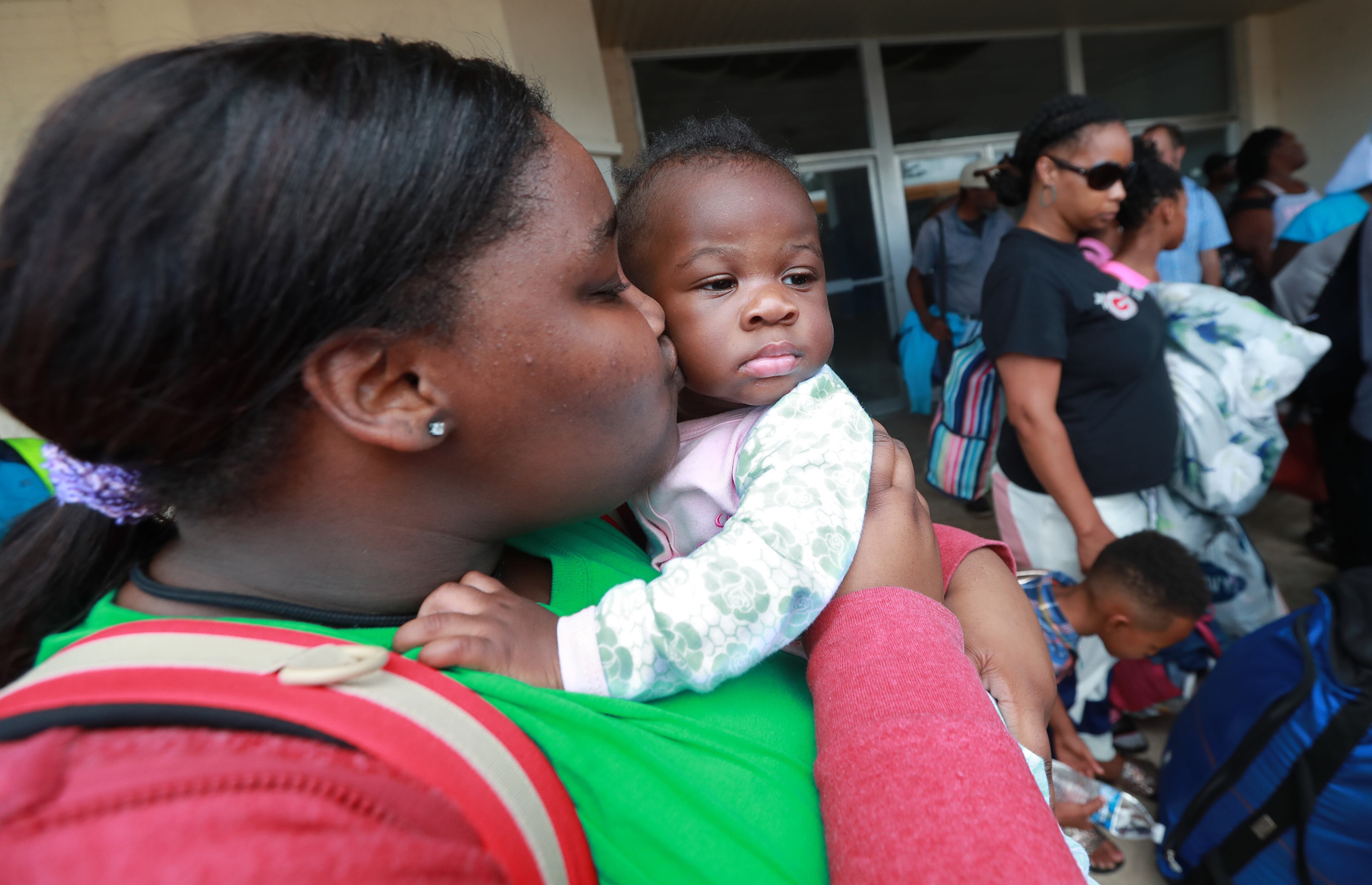 September 2, 2019 Brunswick: Verida Hemphill gives her neice Laniyah Harsey, 6-months, a kiss on the cheek to comfort her as hundreds of local residents board buses at Lanier Plaza to evacuate the area under mandatory evacuation ahead of Hurricane Dorian for a inland shelter in Columbus on Monday, Sept. 2, 2019, in Brunswick. Curtis Compton/ccompton@ajc.com