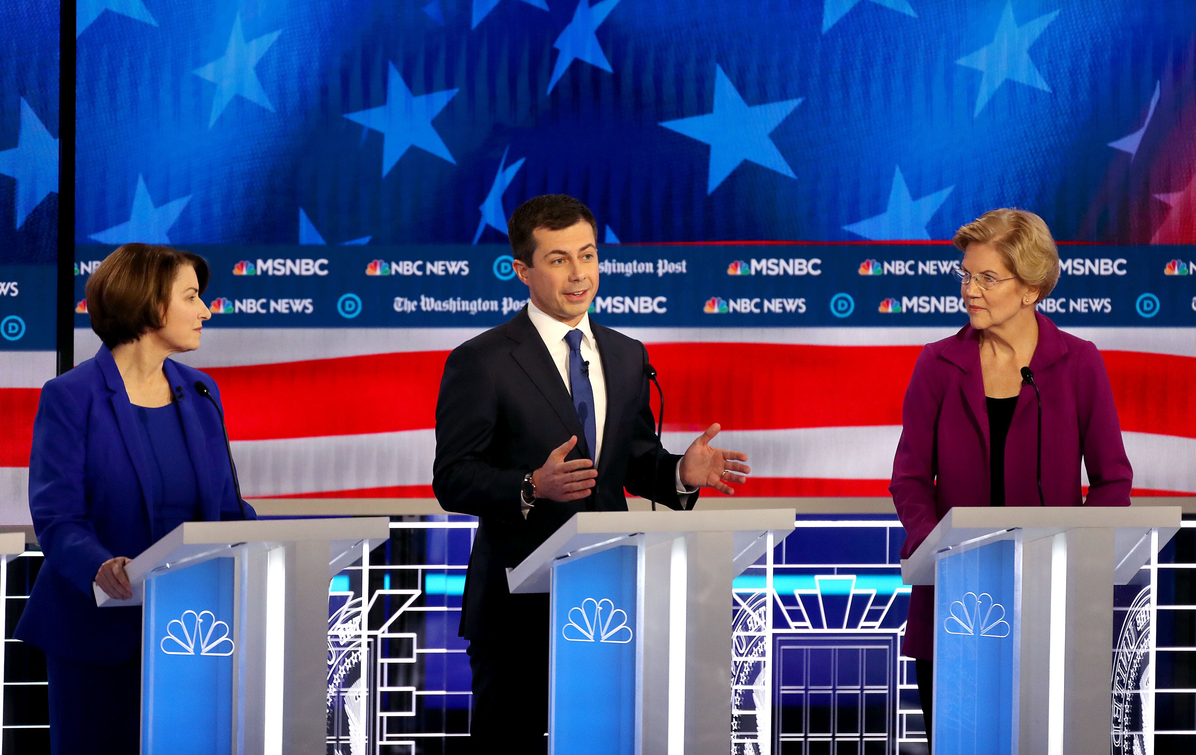 11/20/2019 -- Atlanta, Georgia -- Mayor Pete Buttigieg (center) speaks as Senator Amy Klobuchar (left) and Senator Elizabeth Warren look on, during the MSNBC/The Washington Post Democratic Presidential debate inside the Oprah Winfrey Soundstage at Tyler Perry Studios, Monday, November 20, 2019. (Alyssa Pointer/Atlanta Journal Constitution)