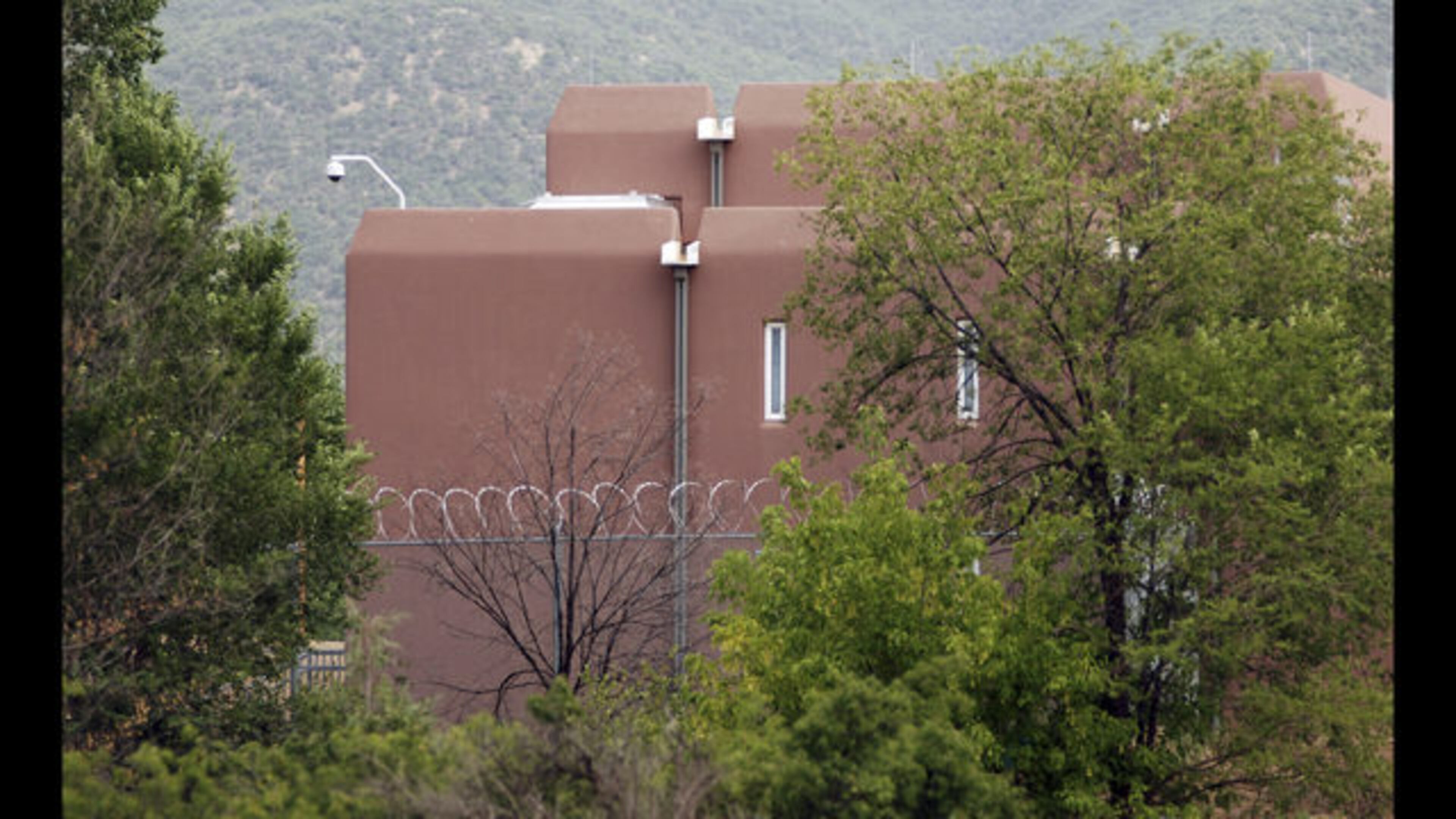 The Taos county jail, where three people accused of child abuse at a desert compound are awaiting release, is shown Wednesday, Aug. 15, 2018, in Taos, N.M. Security was boosted at the judiciary complex amid threats against the state judge who cleared the way for the defendants to leave jail. (AP Photo/Morgan Lee)