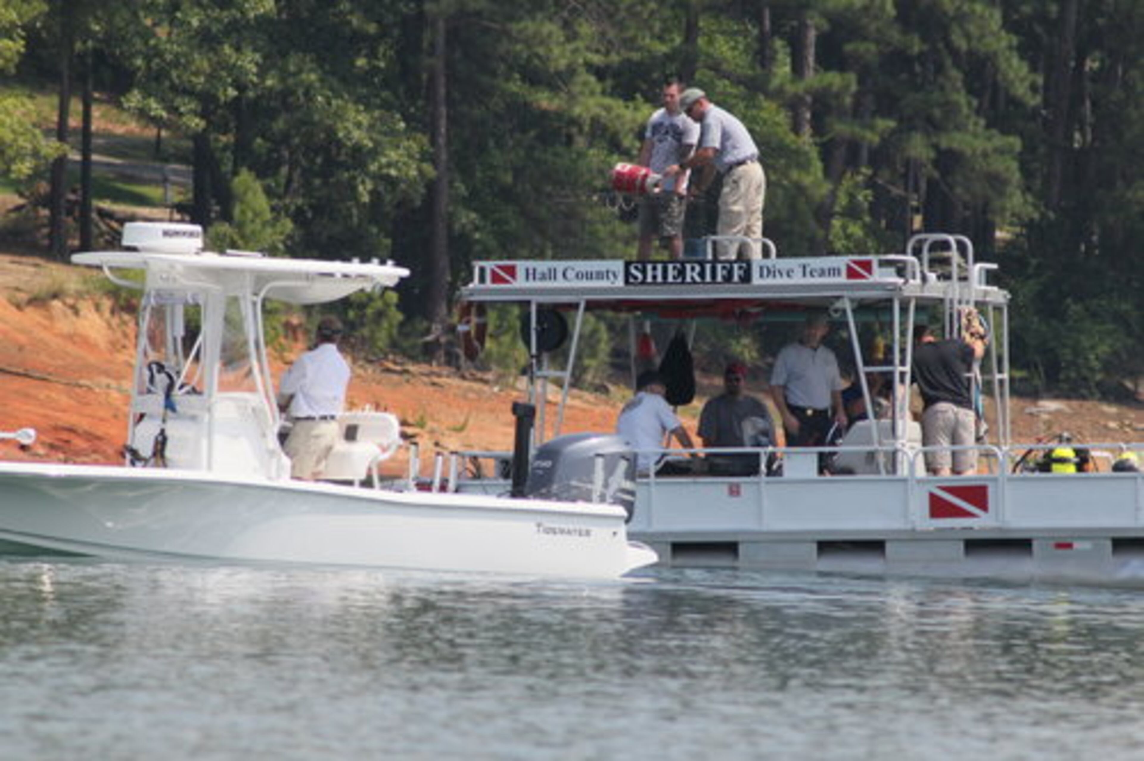 The Hall County Sheriff Dive Team search for a missing 13-year-old boy on Lake Lanier Tuesday, June 19, 2012.
