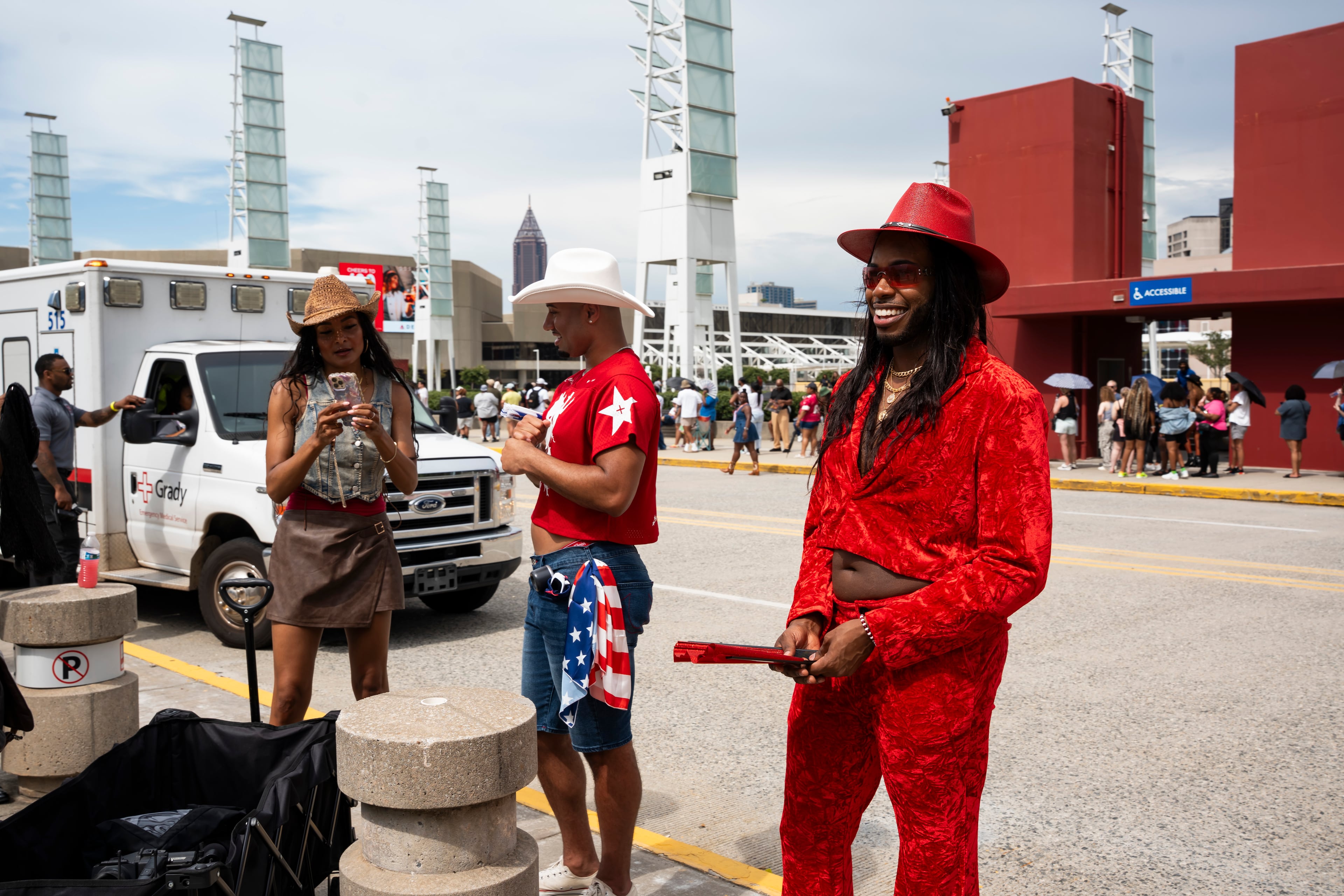 Fans dressed in colorful cowboy attire wait in line outside Beyoncé's Cowboy Carter concert in Atlanta on Thursday, July 10, 2025. (Olivia Bowdoin for the AJC)