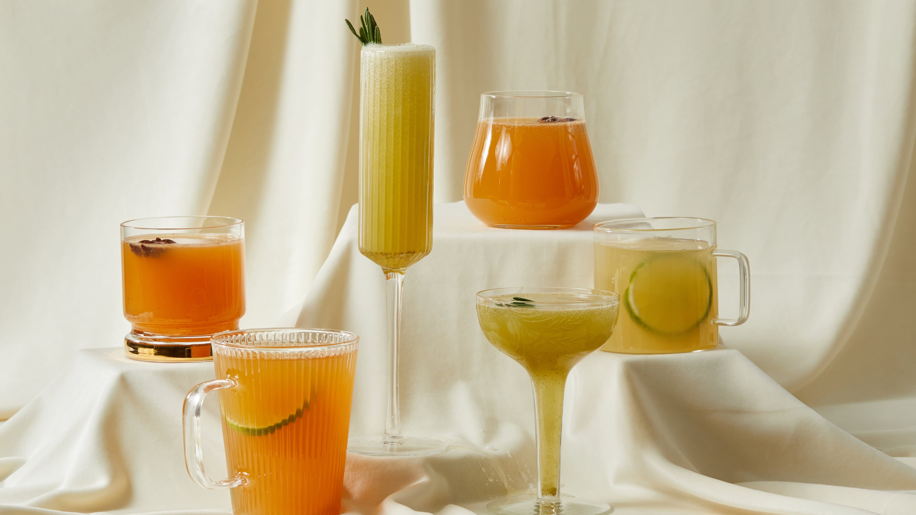 From left: Spiced Apple-Rye Punch, Smoked Tea Toddy, Charred Lemon and Rosemary Gin Sparkler, Spiced Apple Punch, Charred Lemon and Rosemary Sparkler, Mezcal Hot Toddy. ((Prop styling by Morgan Locke, food styling by Kate Williams / Bailey Garrot for The Atlanta Journal-Constitution.)