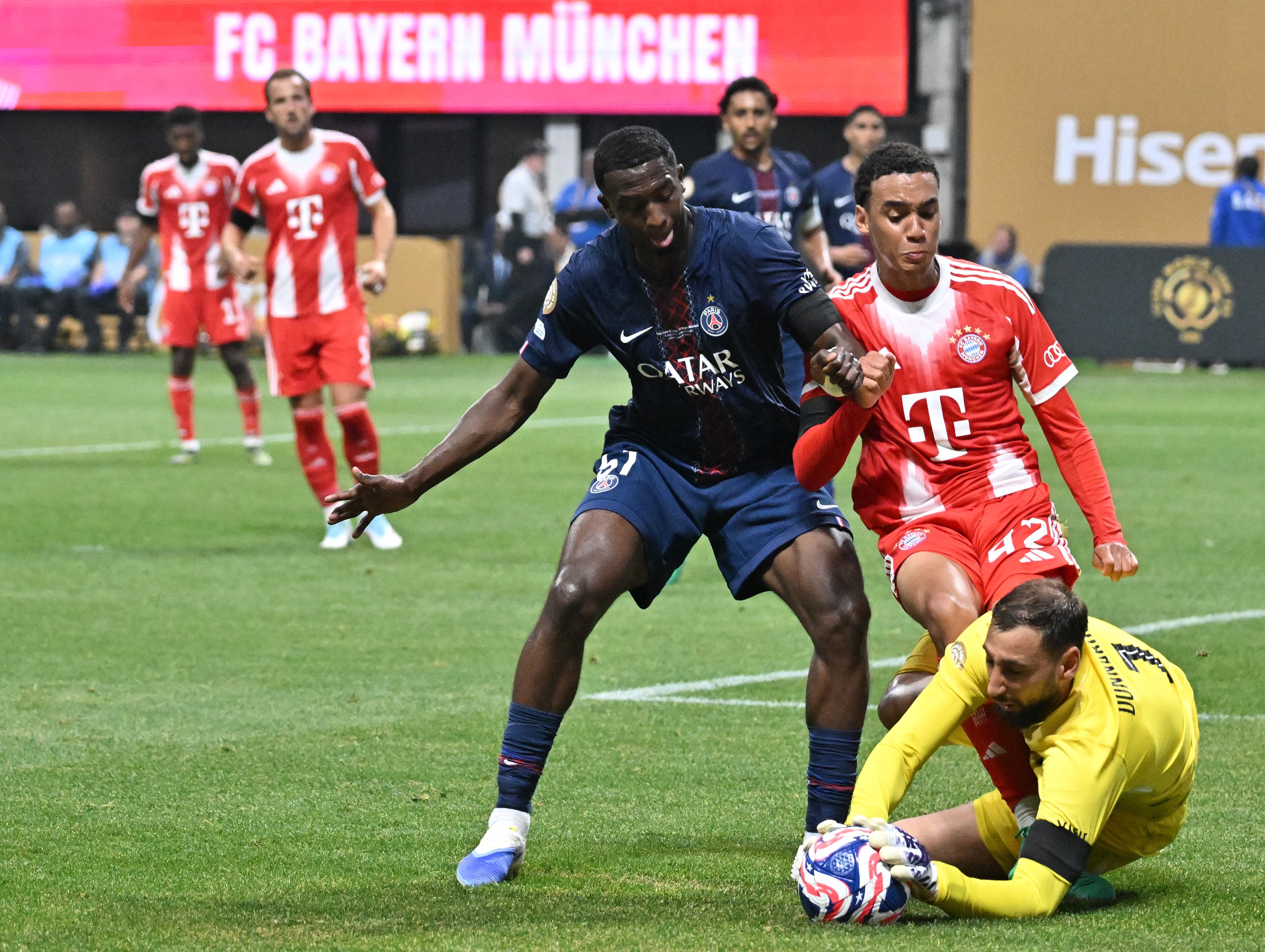 Paris Saint-Germain goalkeeper Gianluigi Donnarumma (ground) blocks a shot by Bayern Munich midfielder Jamal Musiala (right) during the first half of the Club World Cup quarterfinals match at Mercedes-Benz Stadium on Saturday, July 5, 2025, in Atlanta. Paris Saint-Germain won 2-0 over Bayern Munich. (Hyosub Shin/AJC)