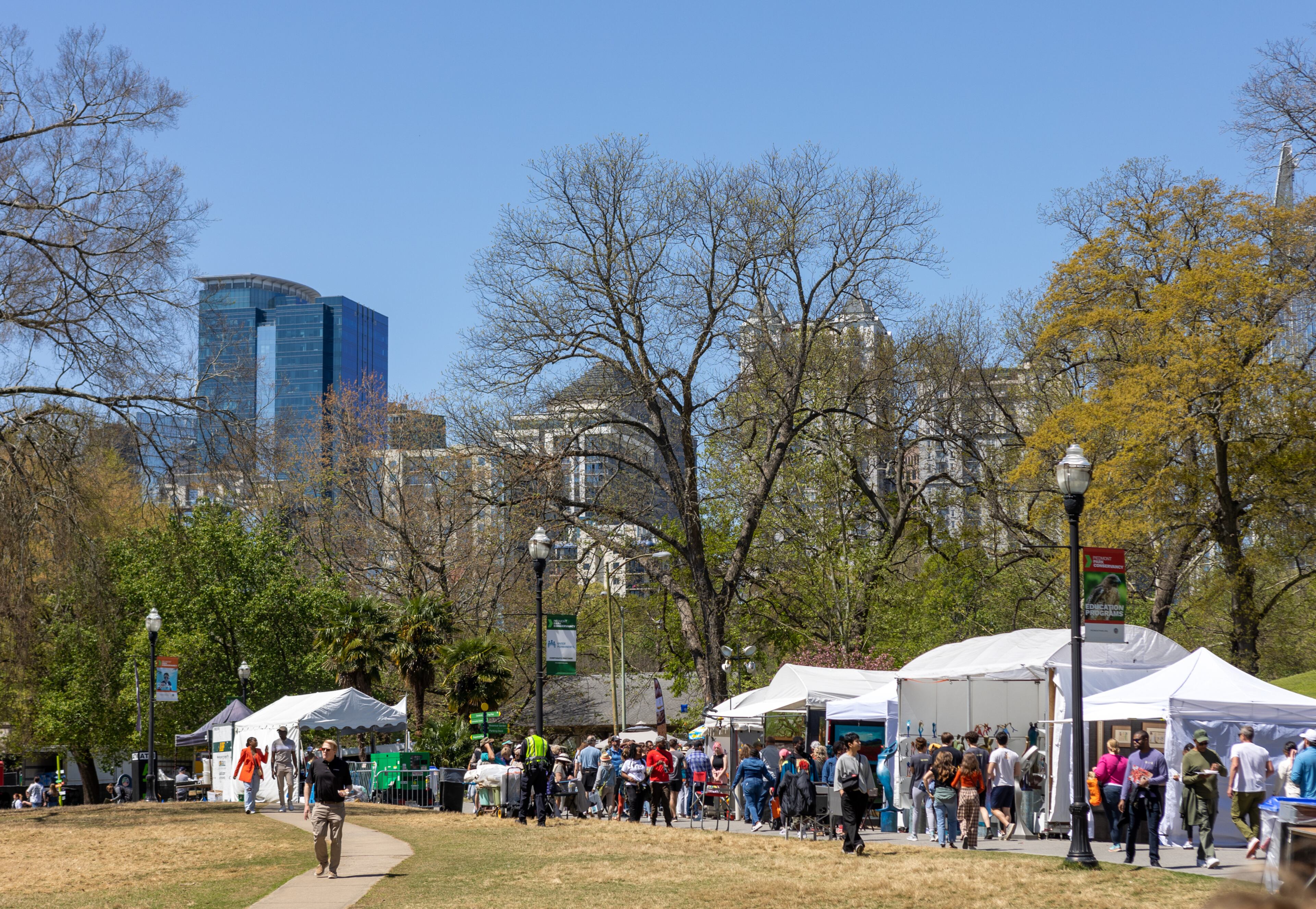 People enjoy the 86th annual Atlanta Dogwood Festival in Piedmont Park on April 10, 2022. The three-day event included arts and craft, kids area, food and games. (Jenni Girtman for The Atlanta Journal-Constitution)