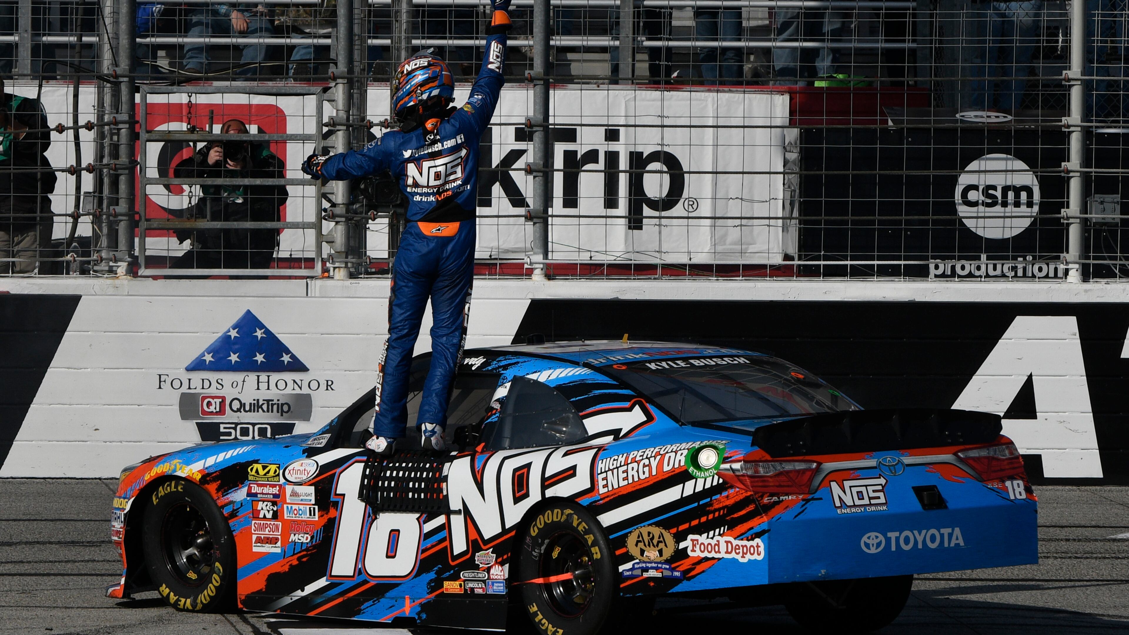 Kyle Busch celebrates at the finish line after winning a NASCAR Xfinity auto race at Atlanta Motor Speedway in Hampton, Ga., Saturday, March 4, 2017. (AP Photo/John Amis)