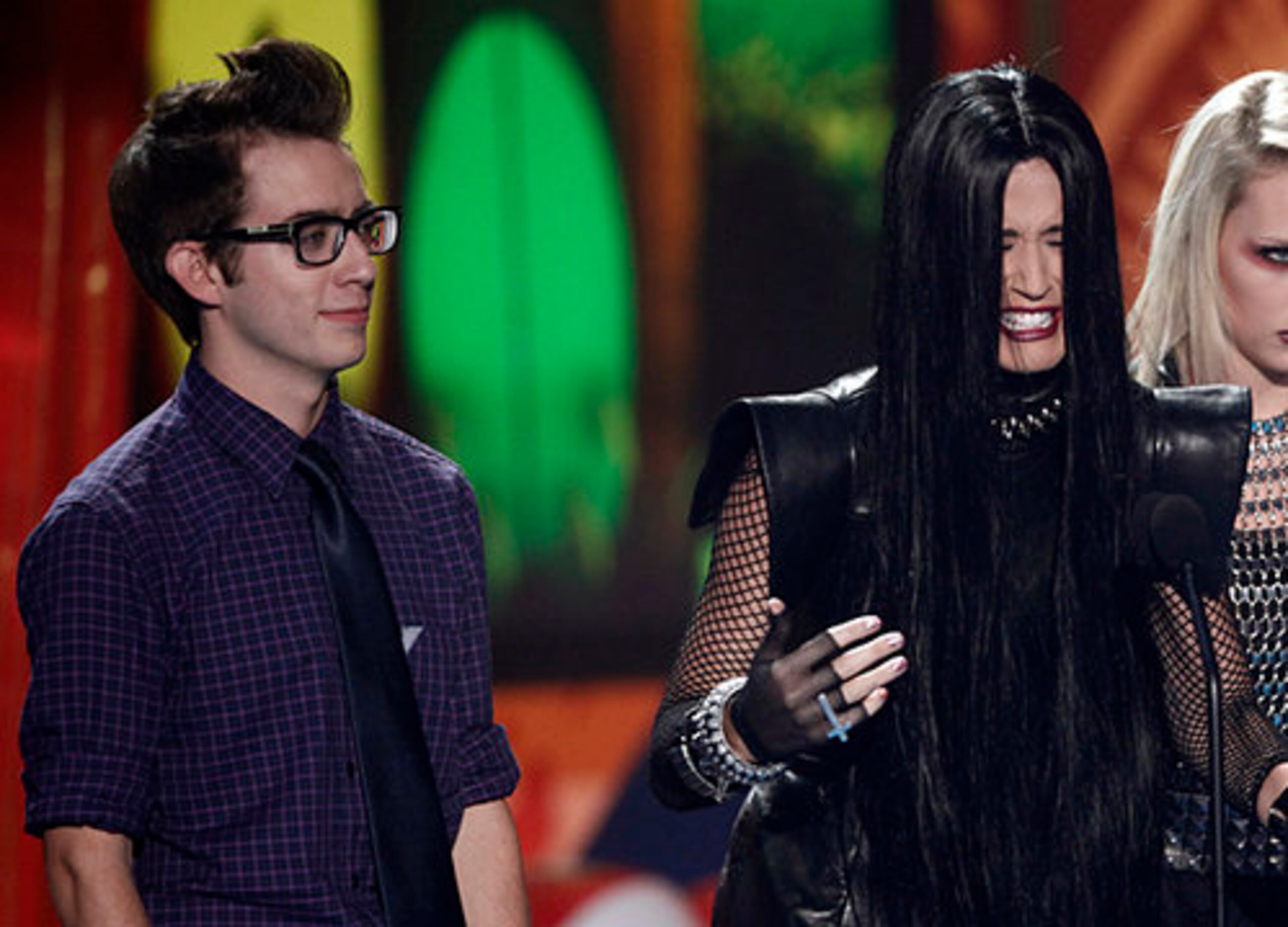 Kevin McHale watches as host Katy Perry speaks onstage.