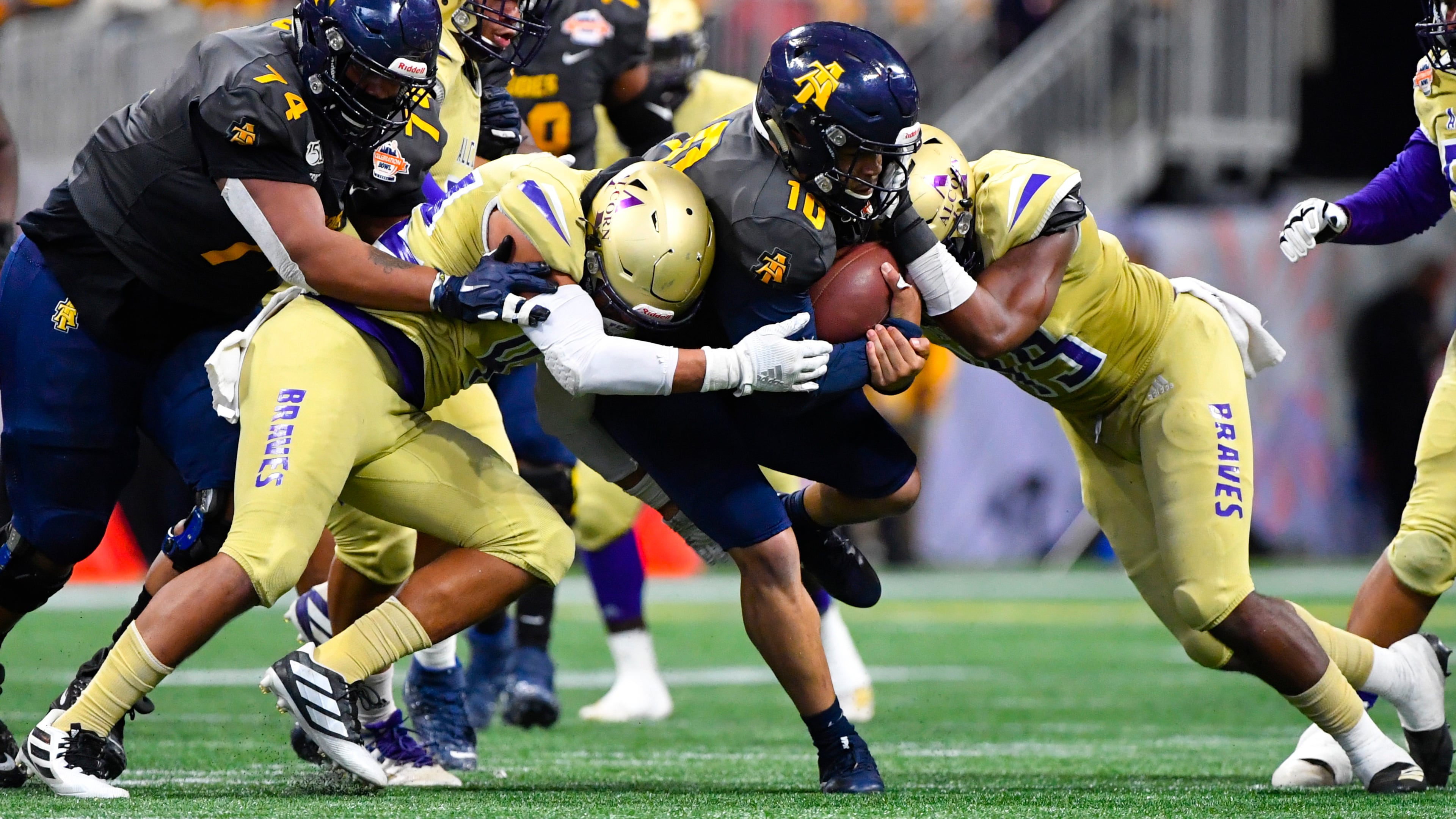 North Carolina A&T quarterback Kylil Carter (10) is brought down by Alcorn State players during the second half of the Celebration Bowl Saturday, Dec. 21, 2019, at Mercedes-Benz Stadium in Atlanta.