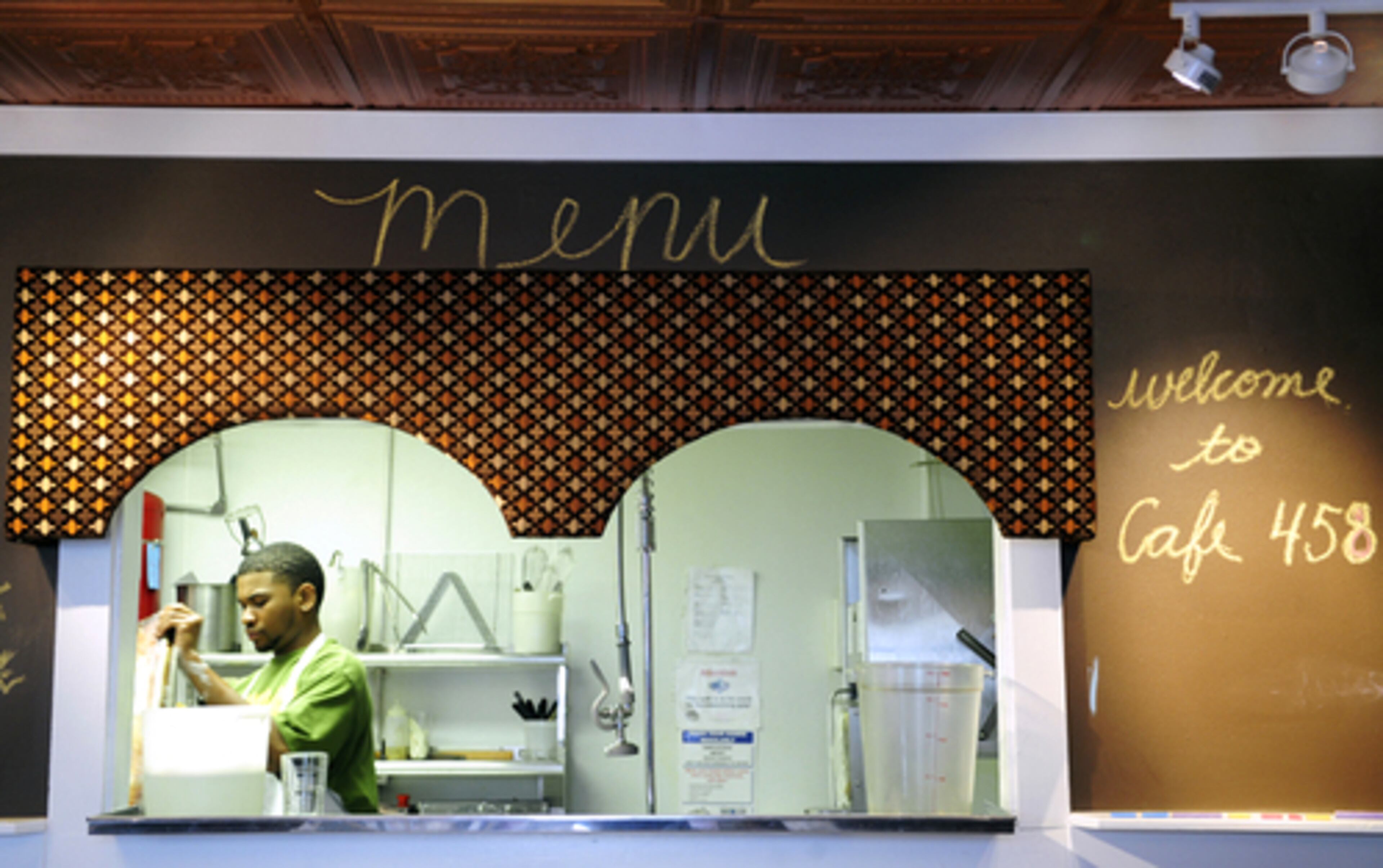 Ellis Cox of Austell prepares for the lunch rush. A chalkboard that surrounds the kitchen window welcomes diners and gives the day's menu.