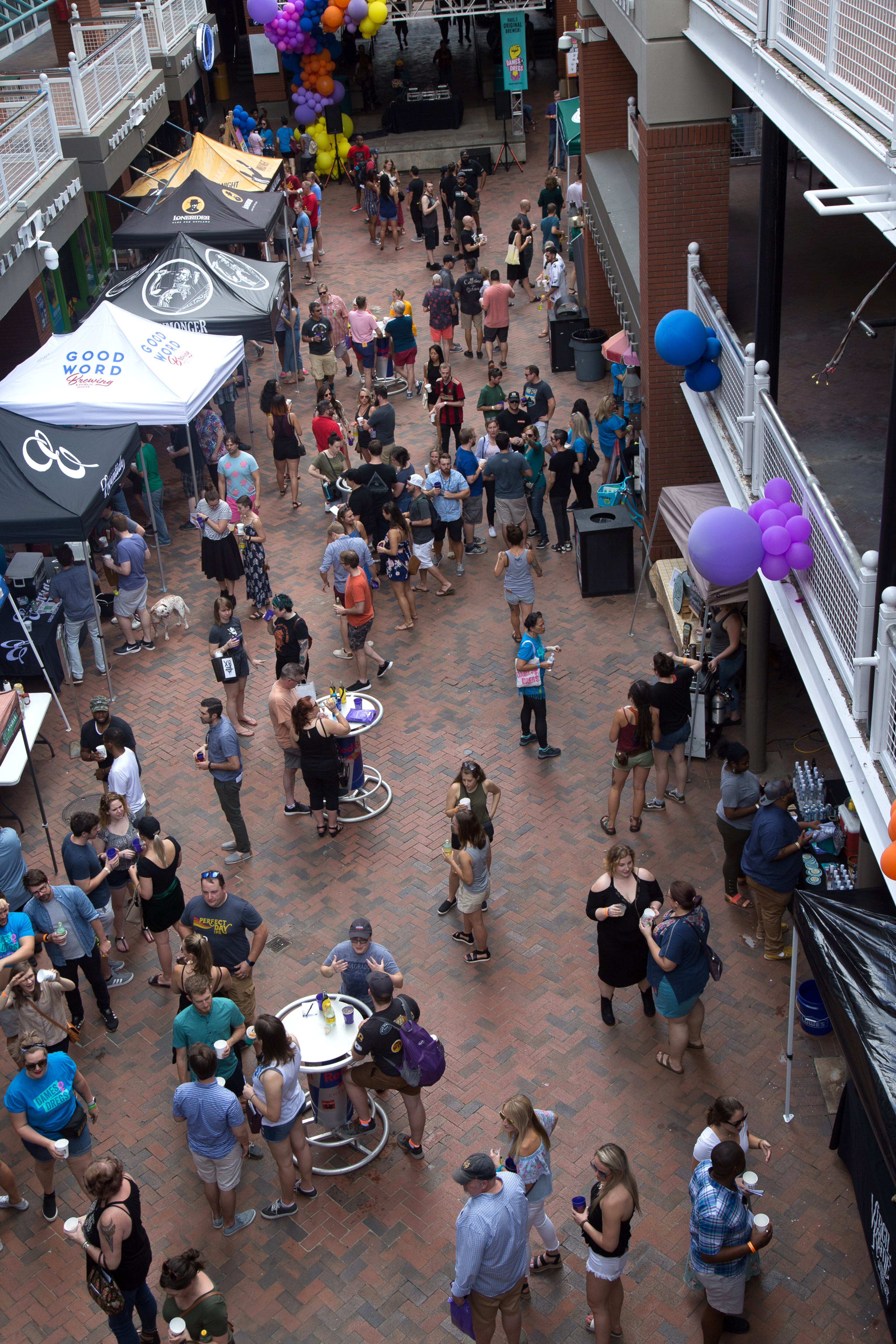 People walk around Kenny's Alley looking over the various vendor booths during The Dames + Dregs Beer Festival in Atlanta GA August 11, 2018. STEVE SCHAEFER / SPECIAL TO THE AJC