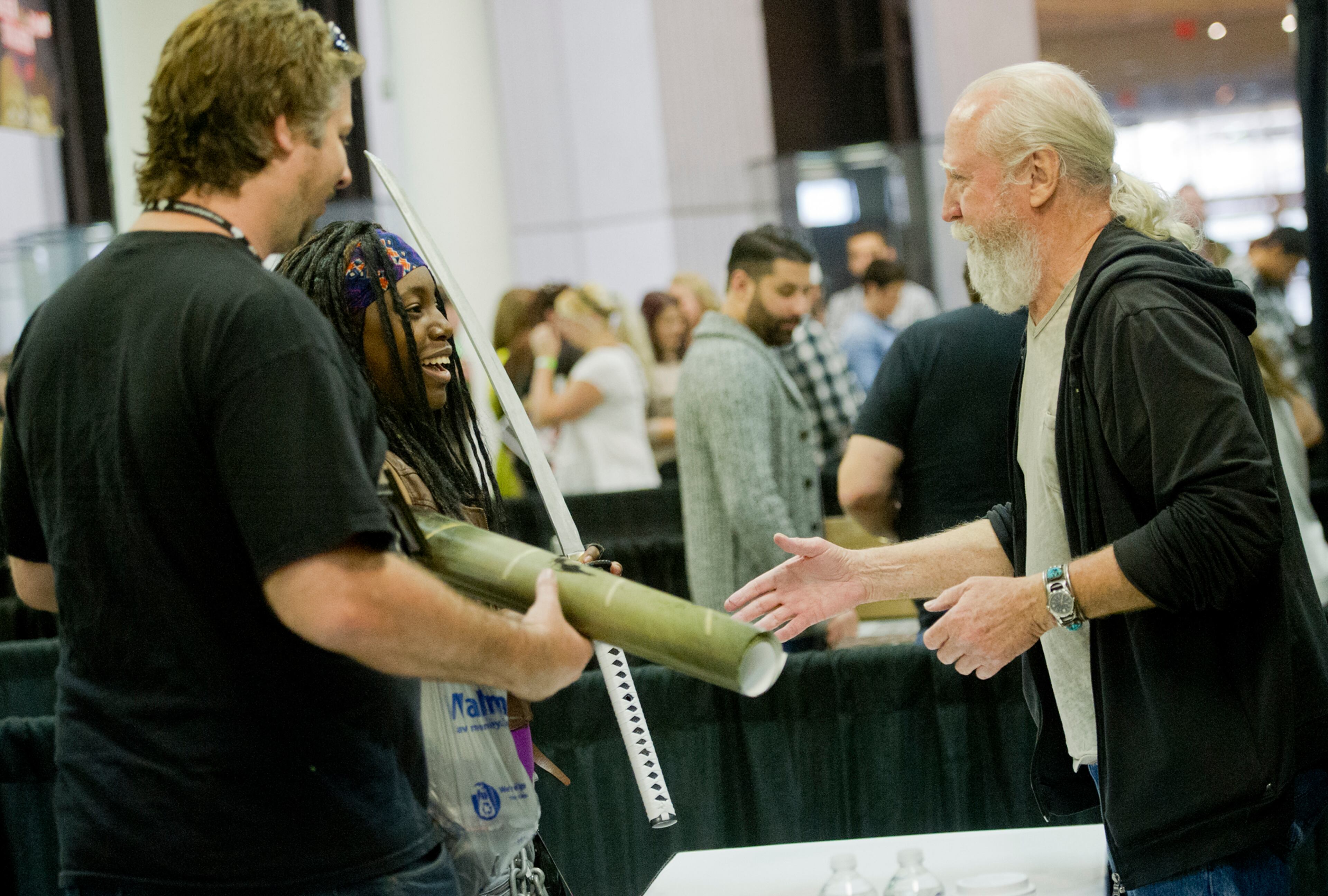 Scott Wilson (right), who plays Hershel Greene on "The Walking Dead," shakes hands with Kina Richardson and her husband William during Walker Stalker Con at the Atlanta Convention Center at AmericasMart on Nov. 2, 2013.