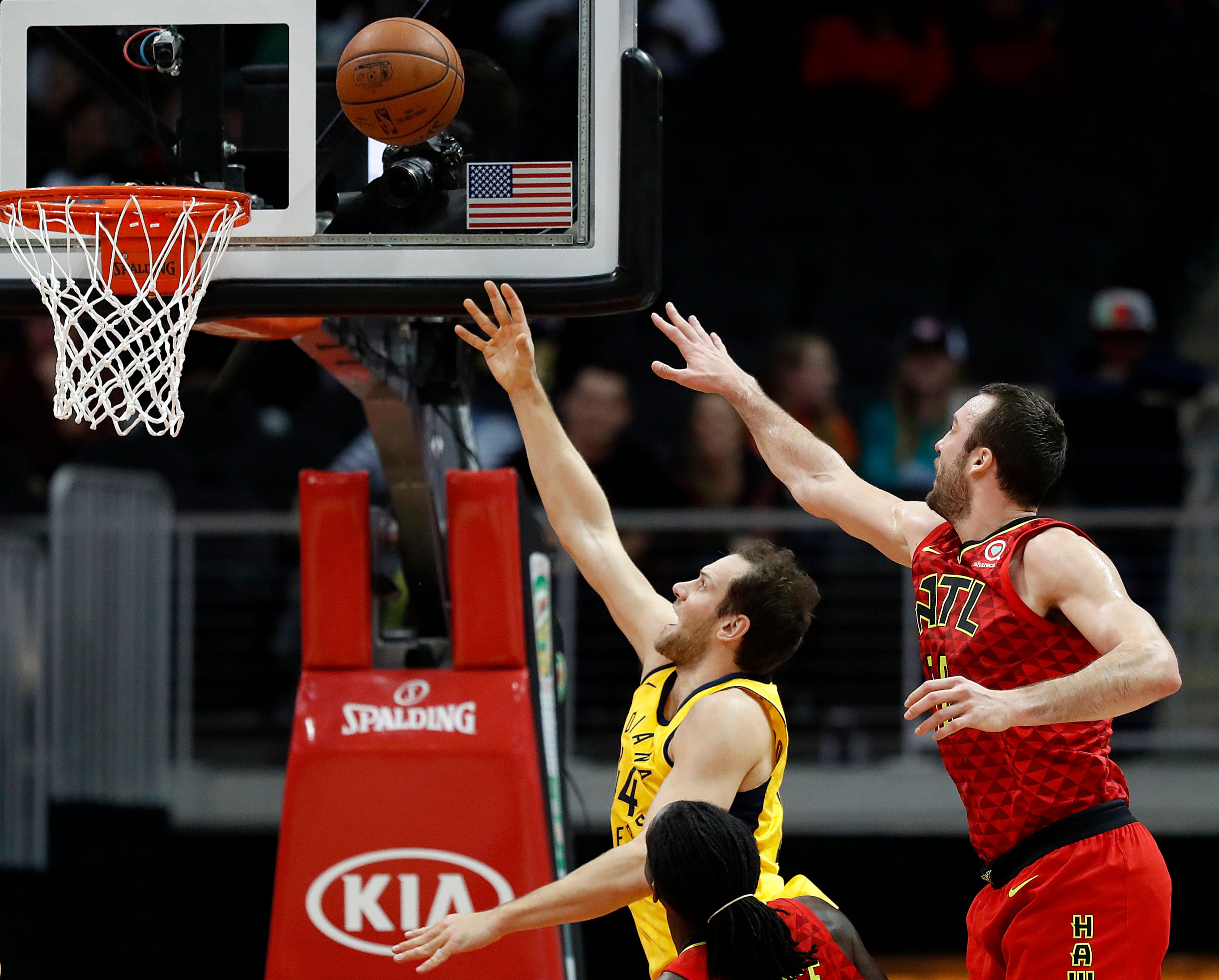 Indiana Pacers' Bojan Bogdanovic, left, of Croatia, puts up a shot past Atlanta Hawks' Miles Plumlee in the first quarter of an NBA basketball game in Atlanta, Wednesday, Dec. 20, 2017. (AP Photo/David Goldman)