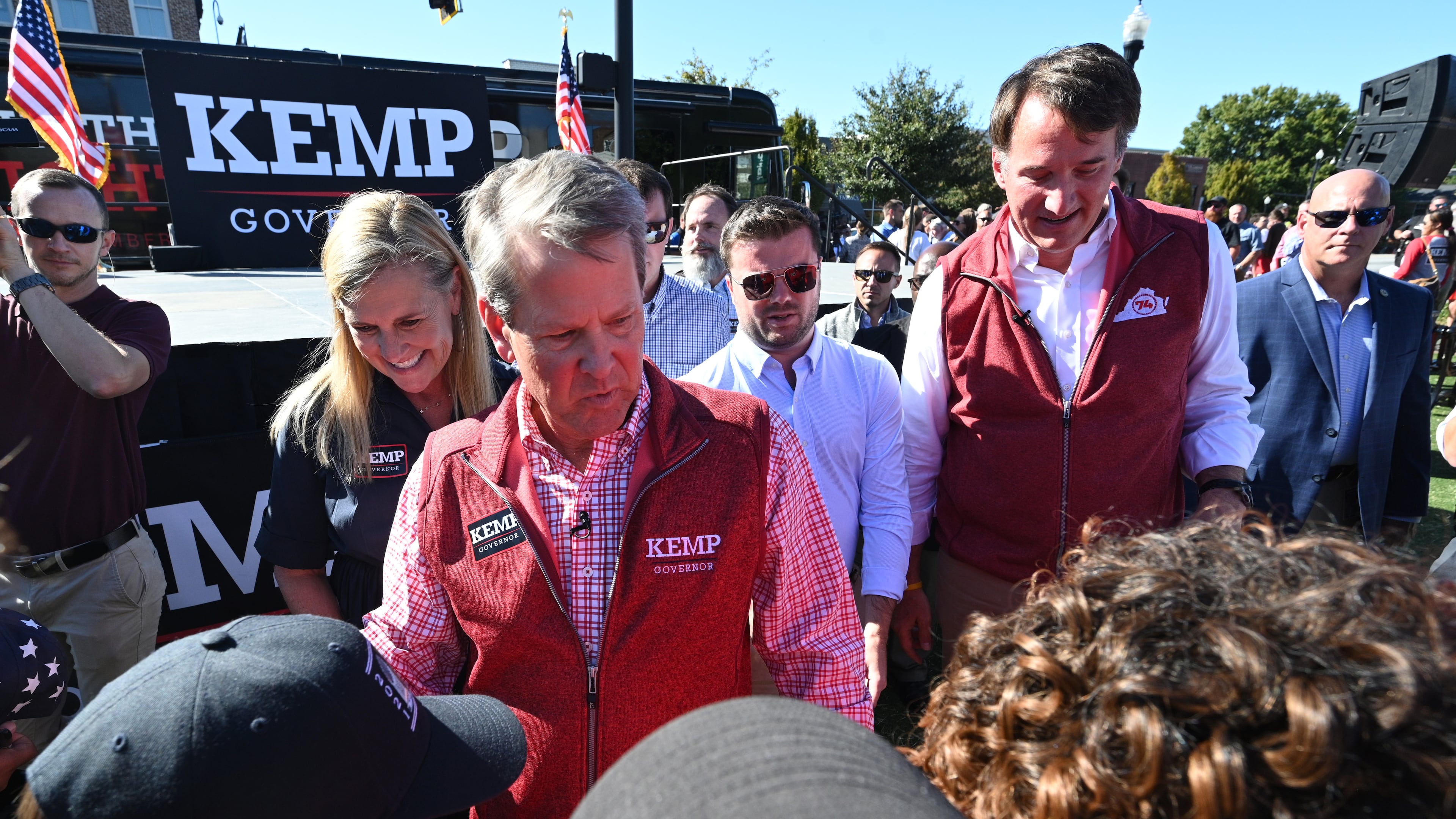 Georgia Gov. Brian Kemp, left, and Virginia Gov. Glenn Youngkin campaign together Tuesday in Alpharetta, one of Kemp's first visits this election cycle in the suburbs. (Hyosub Shin / Hyosub.Shin@ajc.com)