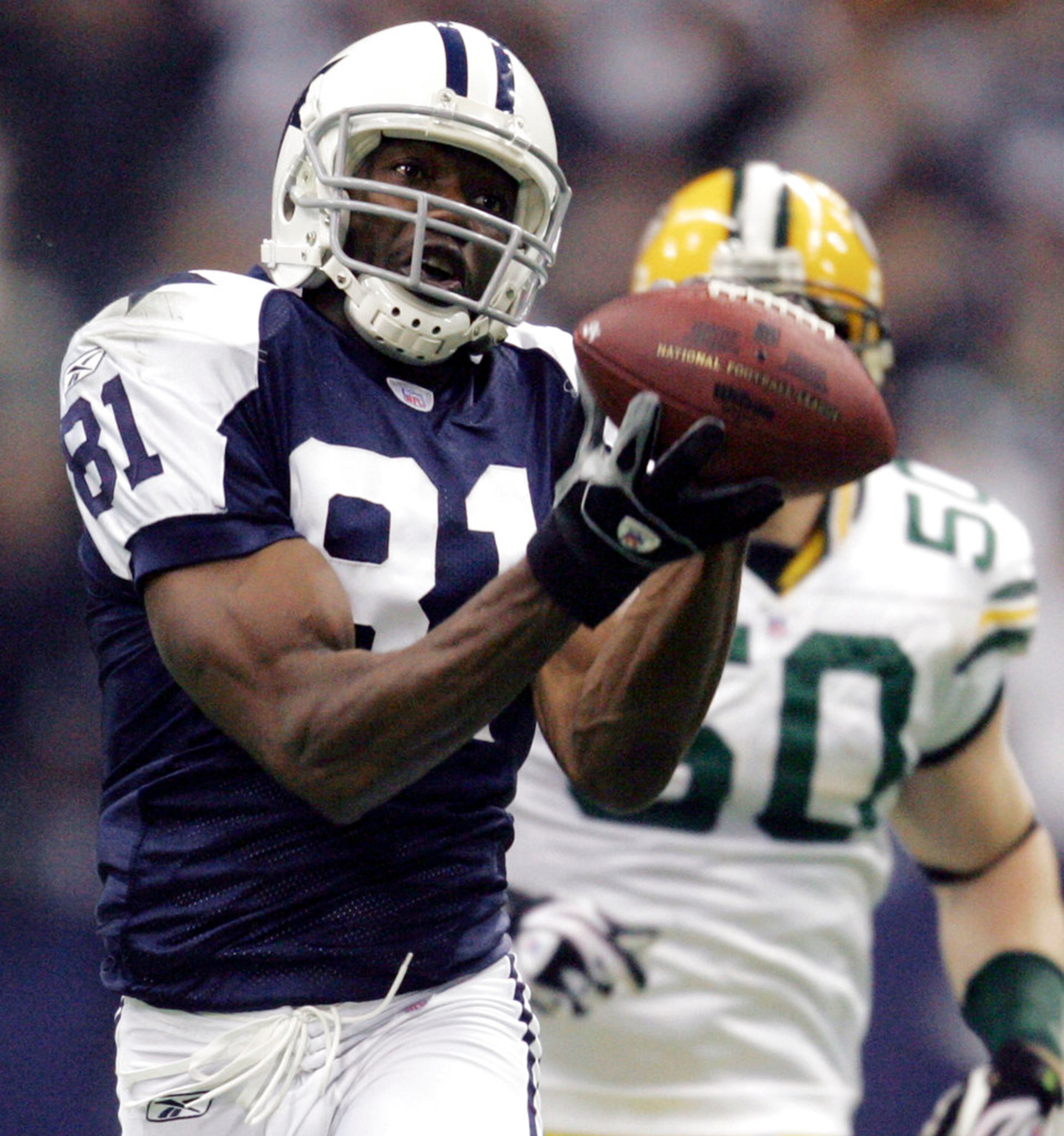 FILE - In this Nov. 29, 2007, file photo, Dallas Cowboys wide receiver Terrell Owens (81) pulls in a 48-yard pass as Green Bay Packers linebacker A.J. Hawk (50) defends in the second quarter in their NFL football game in Irving, Texas. Owens was elected to the Pro Football Hall of Fame on Saturday, Feb. 3, 2018.(AP Photo/LM Otero)