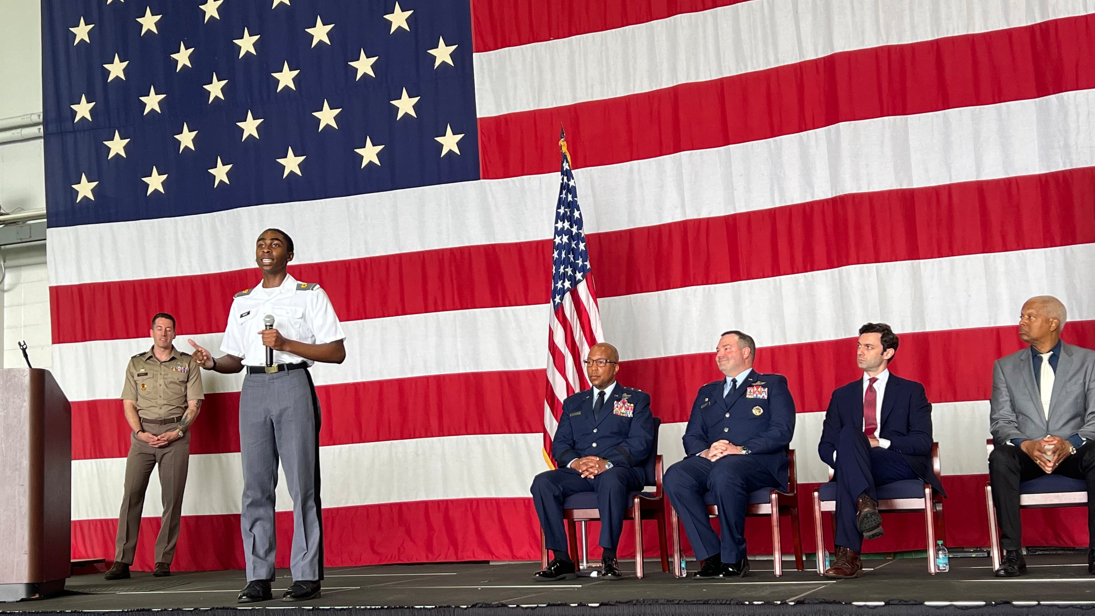 Chad White, a student at the U.S. Military Academy at West Point, speaks to high school students and parents about his experience at West Point as U.S. Sen. Jon Ossoff (second from right) and U.S. Rep. Hank Johnson (right) listen. (Ashley Ahn/AJC)