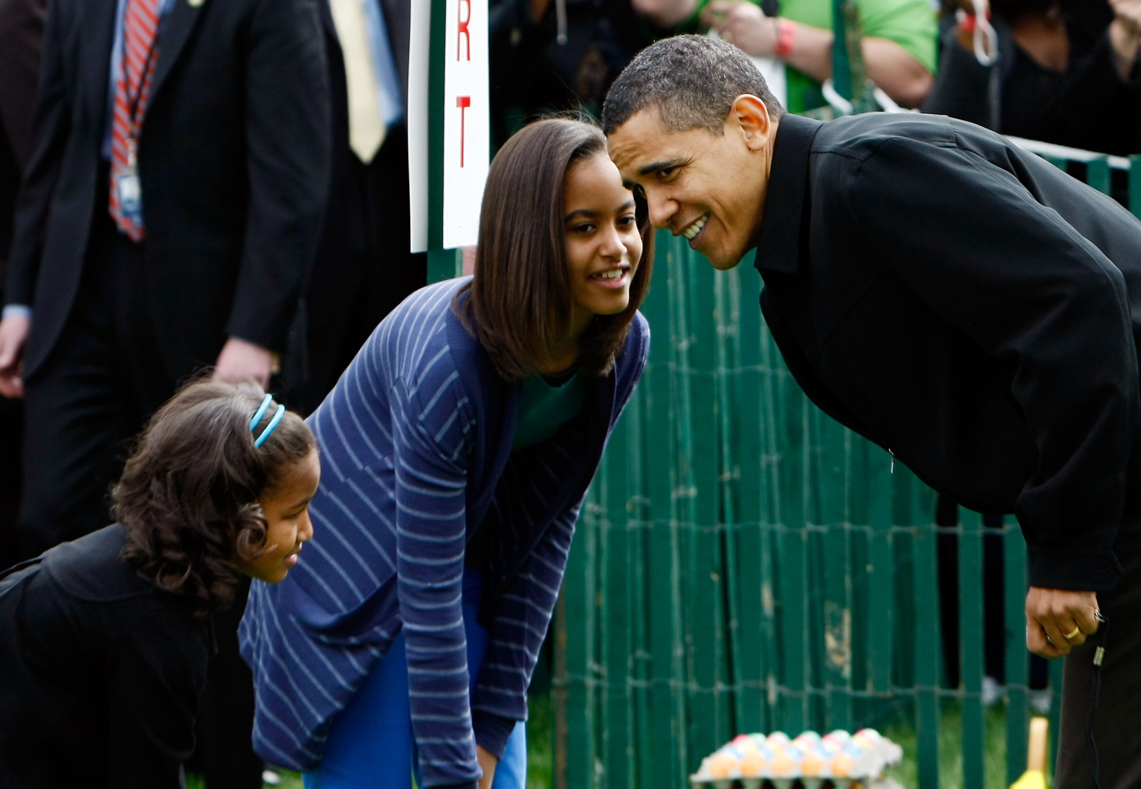 U.S. President Barack Obama (R) checks on his daughters Malia Obama (C) and Sasha Obama before the start of the White House Easter Egg Roll on the South Lawn of the White House April 13, 2009 in Washington, DC. The White House Easter Egg Roll is a tradition dating back to 1878 during the presidency of Rutherford B. Hayes. (Photo by Win McNamee/Getty Images)