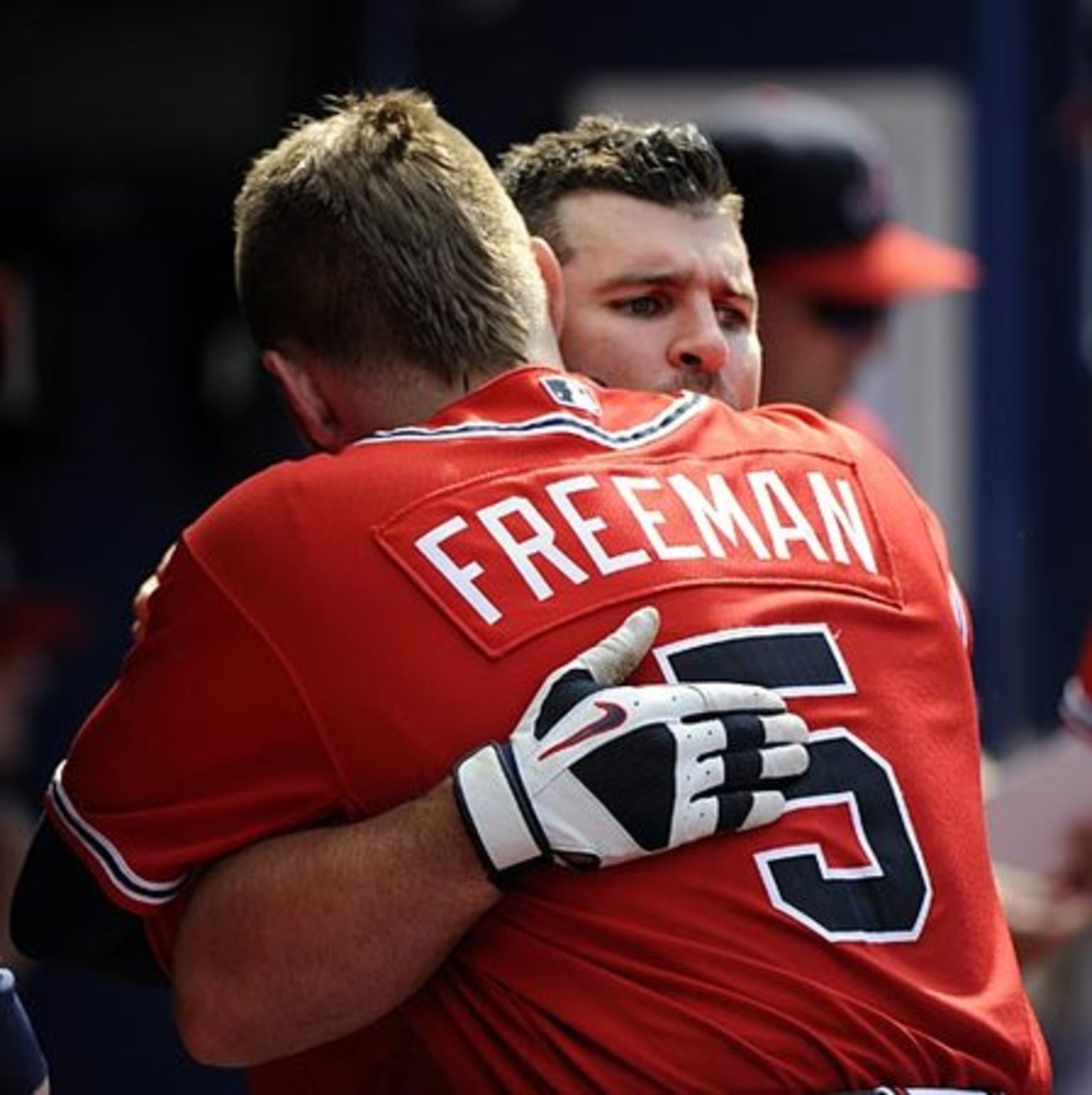 Uggla, right, is hugged by teammate Freddie Freeman in the dugout as the streak ends. "The streak is one thing. I'm more disappointed in the loss," Uggla said. - AP