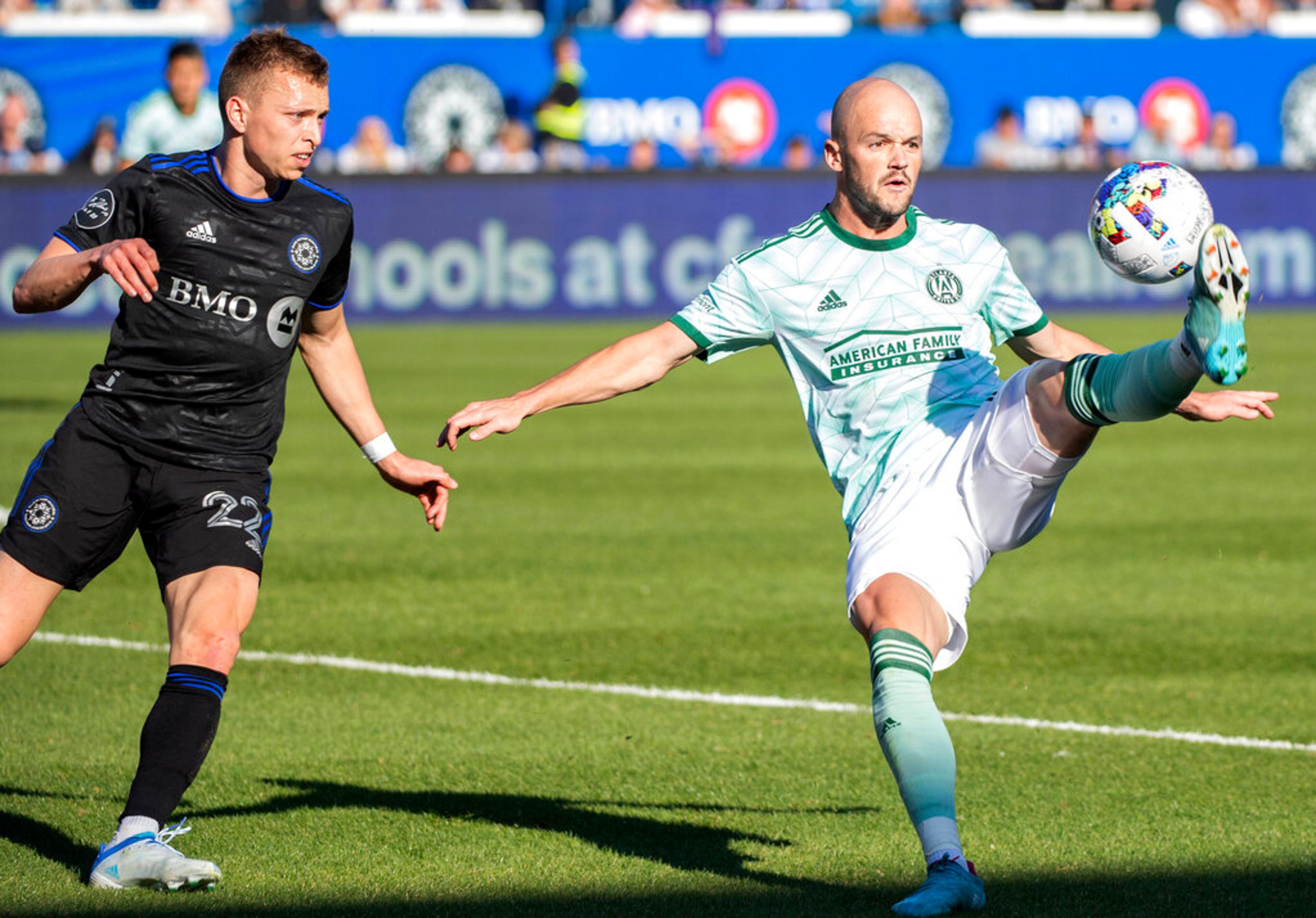 Atlanta United's Andrew Gutman, right, controls the ball as CF Montreal's Alistair Johnston watches during the second half of an MLS soccer game in Montreal, Saturday, April 30, 2022. (Graham Hughes/The Canadian Press via AP)